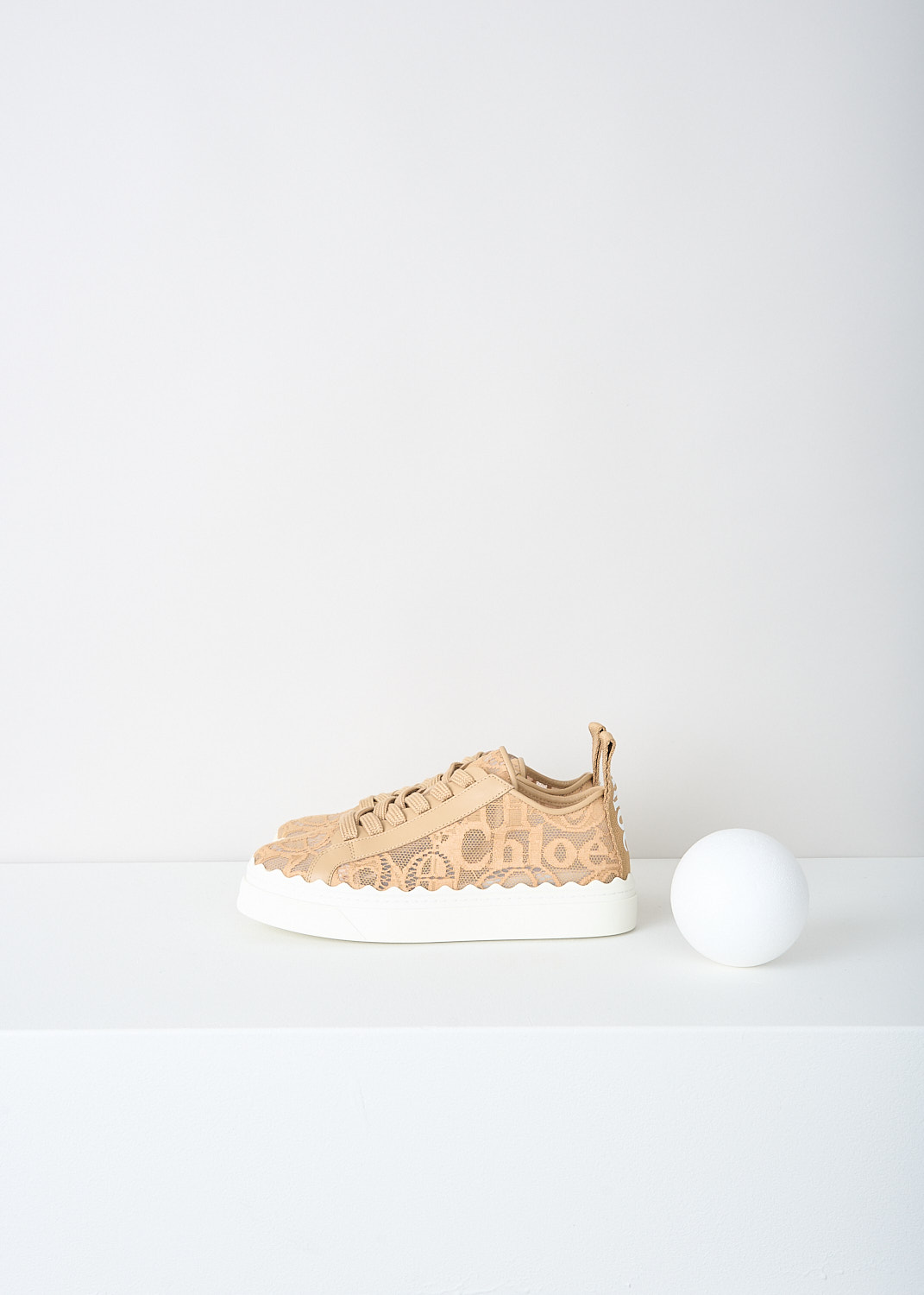 Chloé, Biscotti beige lace Lauren sneakers, CHC19U108D2268_BISCOTTI_BEIGE, Beige, Side, These Biscotti beige lace low-top Lauren sneakers have a lace closure. The white sole has a scalloped edge. These sneakers have a matching pull tab on the heel.
