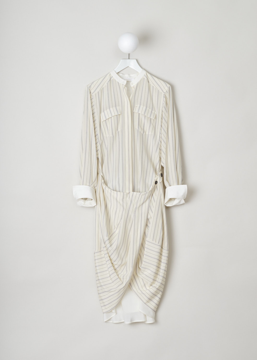 Chloé, Shirt dress with a wrap-around, CHC20URO2632324U_24U_buttercream, Beige, Print, Front, This detailed silk shirt dress features a mandarin collar and long sleeves with cuffs supported by two buttons. The dress has a concealed fastening option in the front with buttons and two flap pockets. The wrap skirt is split in the middle, both half can be fastened with buttons on the other side. 
