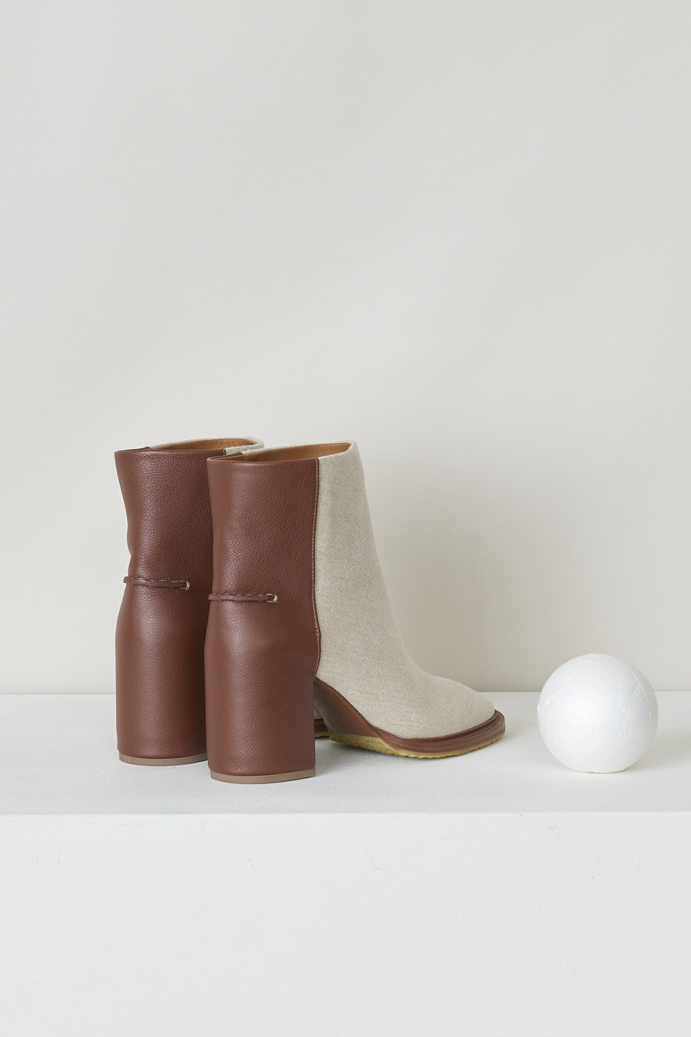 CHLOÃ‰, BEIGE EDITH ANKLE BOOT WITH BROWN HEEL, CHC22S521W89C, Beige, Brown, Back, These beige slip-on ankle boots have a brown leather-clad block heel with white stitching on the ankle. The boots have a round toe and a contrasting brown sole. 
