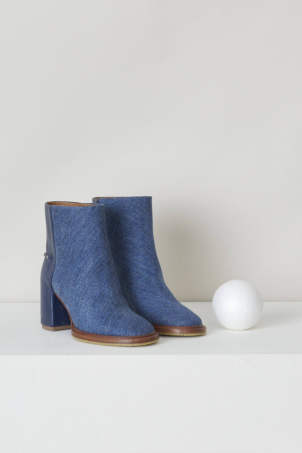 CHLOÃ‰, NAVY BLUE DENIM ANKLE BOOTS, CHC22S521X145C, Blue, Front, These dark navy denim slip-on ankle boots have a blue leather-clad block heel with white stitching on the ankle. The boots have a round toe and a contrasting brown sole. 


