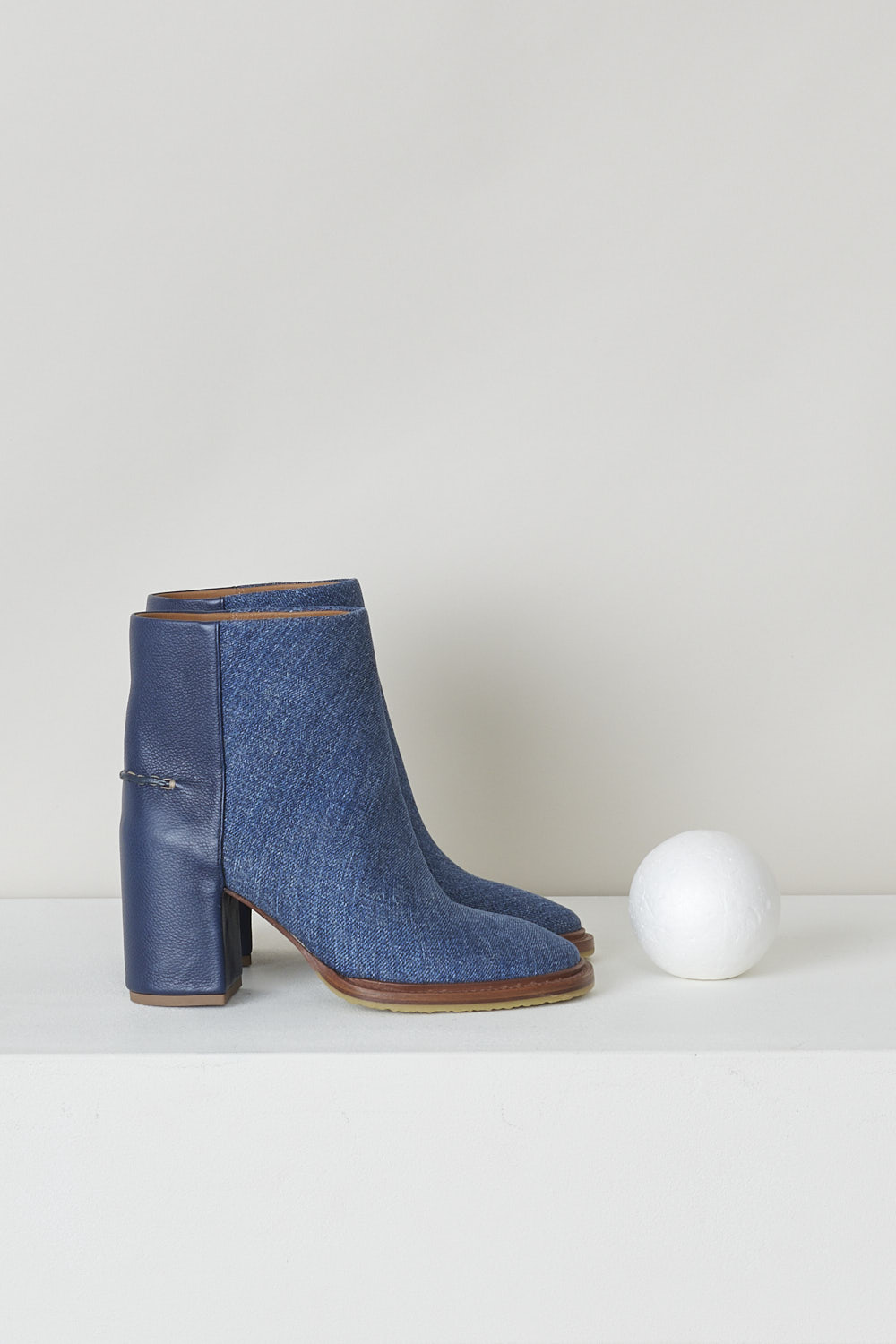 CHLOÃ‰, NAVY BLUE DENIM ANKLE BOOTS, CHC22S521X145C, Blue, Side, These dark navy denim slip-on ankle boots have a blue leather-clad block heel with white stitching on the ankle. The boots have a round toe and a contrasting brown sole. 

