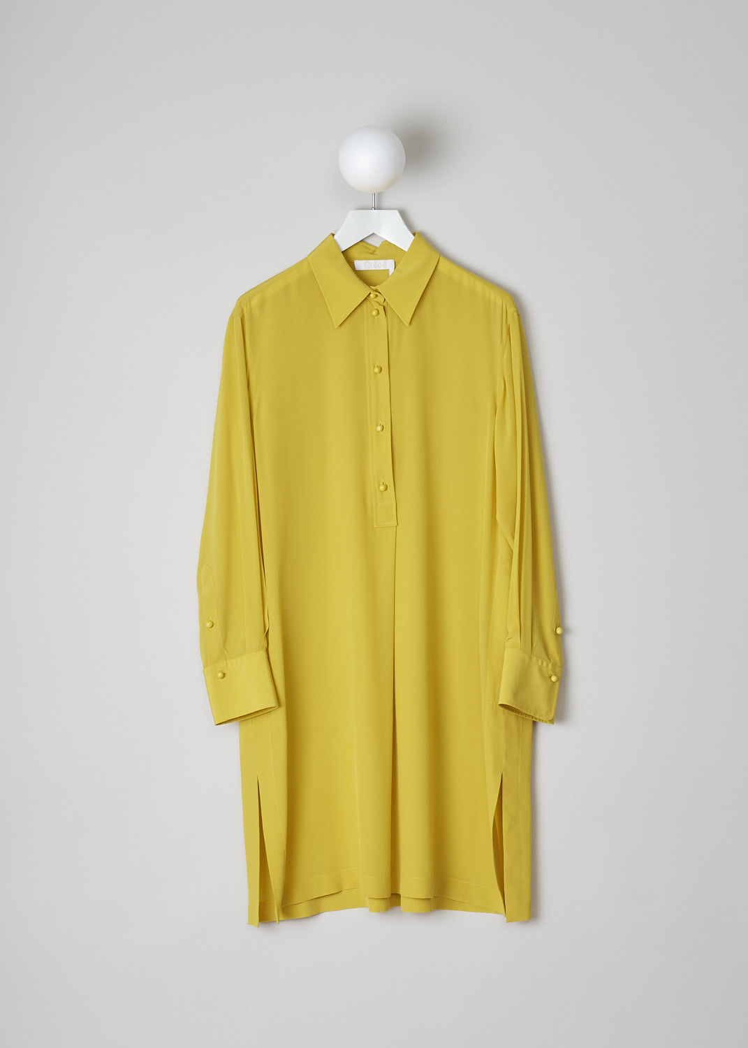 CHLOÃ‰, MUSTARD YELLOW DRESS, CHC22URO64004732_MUSTARD, Yellow, Front, This mustard yellow shirt dress has a spread collar and a front button placket with ceramic buttons that reaches about halfway down. The long sleeves have cuffs with those same ceramic buttons. Slanted pockets are concealed in the side seam. The dress has a straight hemline with side slits. In the back, the dress has a centre box pleat. 
 
