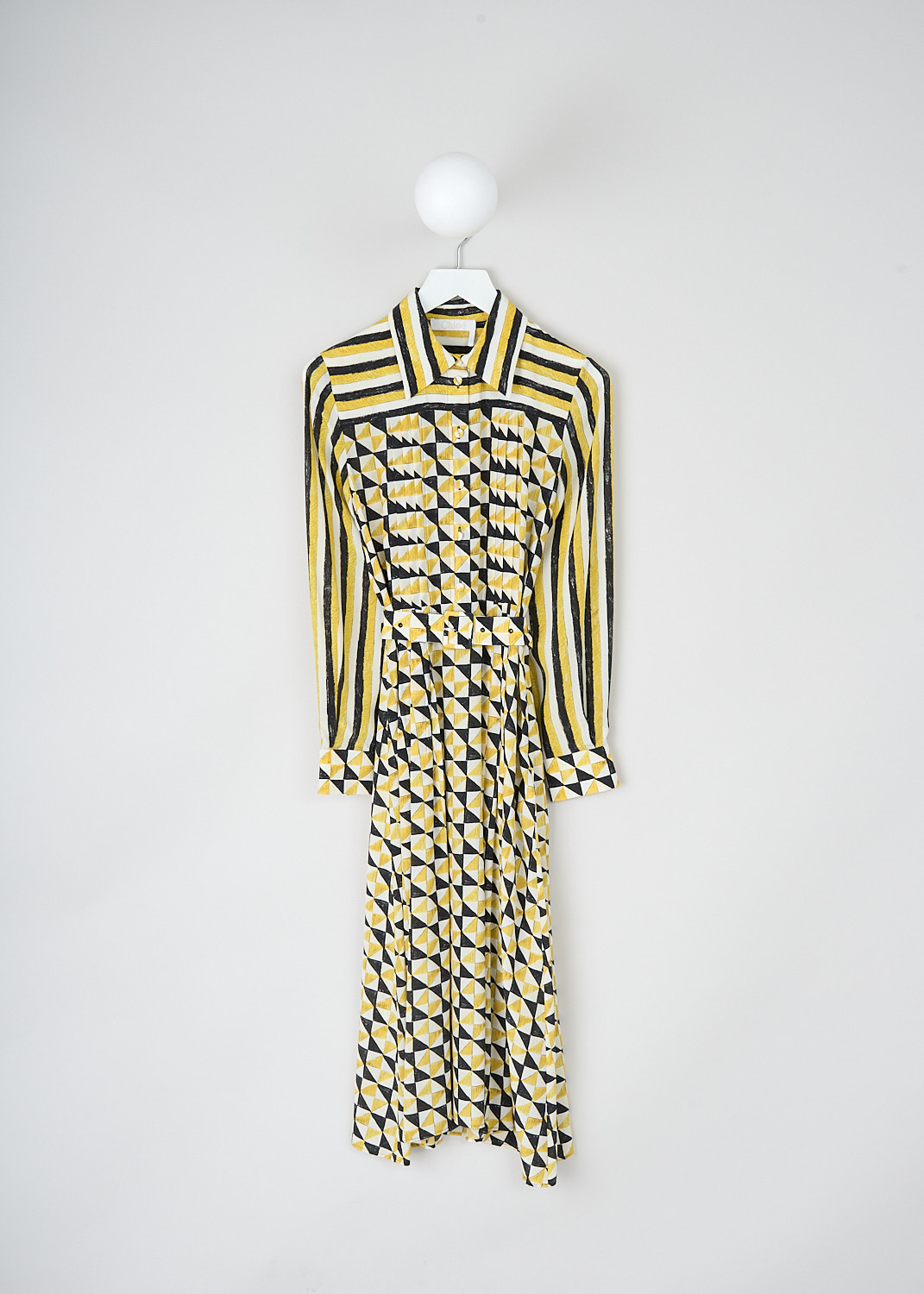 Chloé, Yellow geometric-print shirt dress, CHC23ARO393139CB_MULTICOLOR_2, Yellow, Print, Front, This maxi shirt dress has a geometric print in yellow, white and black. The bodice has a spread collar and a partial front button placket. The long sleeves have buttoned cuffs. A matching fabric belt can be used to cinch in the waist. Knife pleats run along the length of the dress and stop midway on the skirt. A concealed side zip functions as the closure. 

