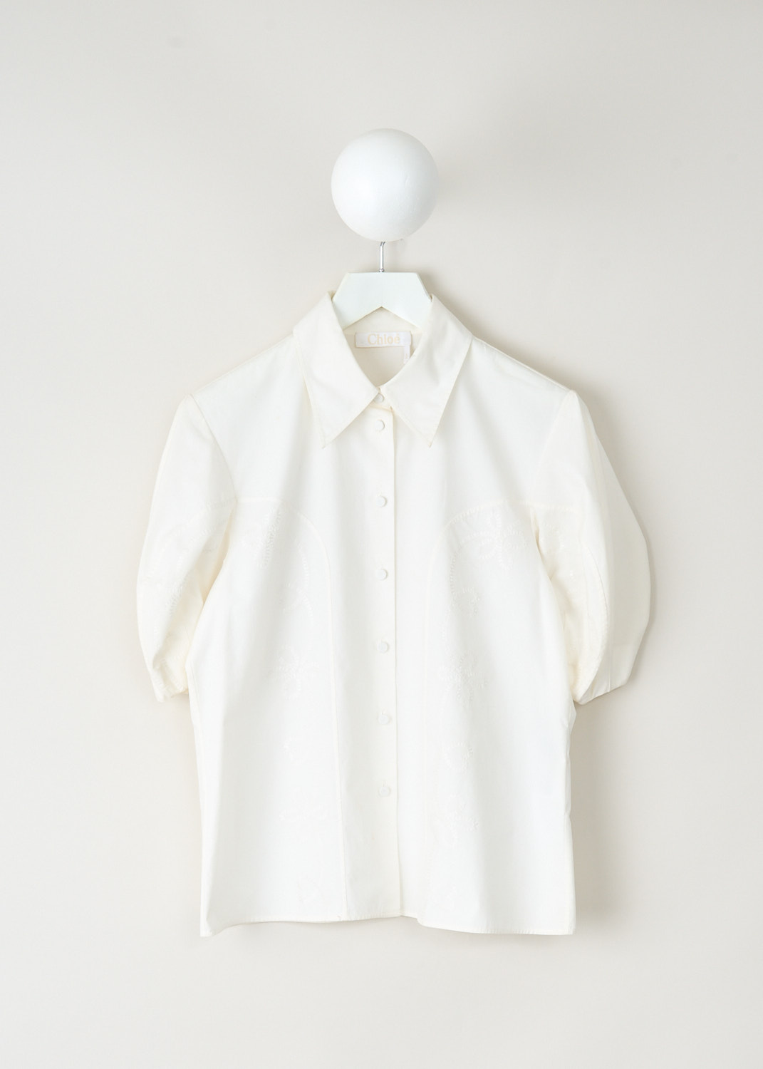 Chloé white blouse with short balloon sleeves, classic collar and broderie anglaise detailing, available at Kiki's Stocksale designer outlet Maastricht.