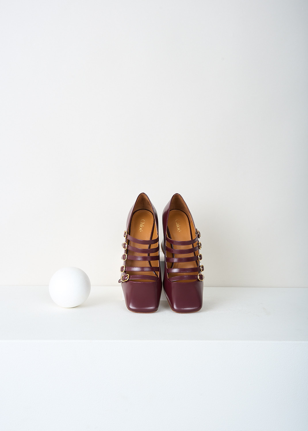 Top view of burnt purple glossed leather and strap construction on Chloé Janis pumps.