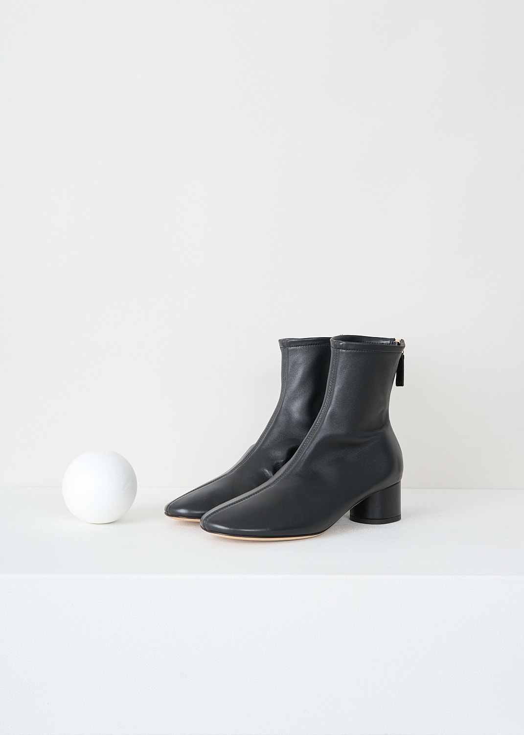 Close-up detail of Dear Frances black leather boots showing circular block heel, round toe and back zip closure