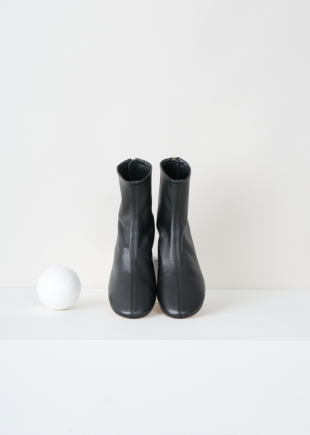 Close-up detail of Dear Frances black leather boots showing circular block heel, round toe and back zip closure