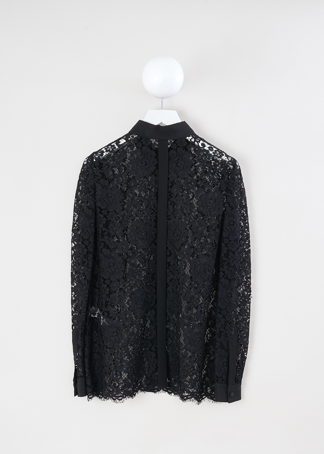 Dolce & Gabbana, Black lace blouse with silk collar, F5F72T_HLMCK_N0000, Black, Back, This black lace blouse with a silk collar, silk front button placket, and long sleeves with buttoned silk cuffs. The blouse features a vertical silk trim down the back and a raw lace hem.
