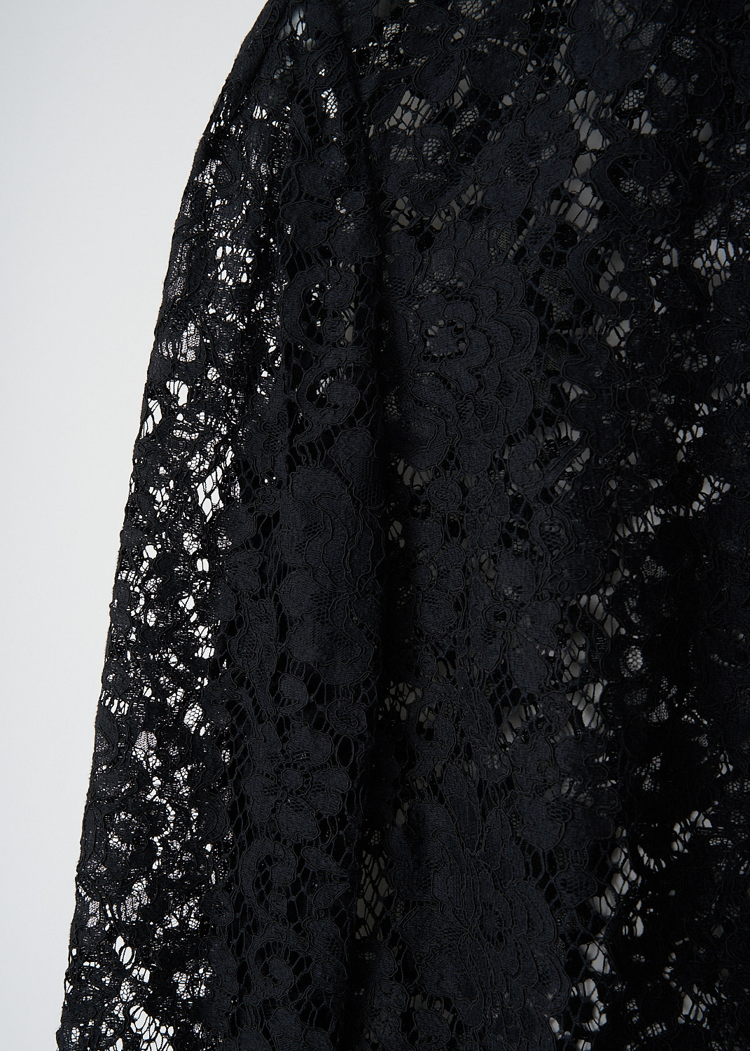 Dolce & Gabbana, Black lace blouse with silk collar, F5F72T_HLMCK_N0000, Black, Detail, This black lace blouse with a silk collar, silk front button placket, and long sleeves with buttoned silk cuffs. The blouse features a vertical silk trim down the back and a raw lace hem.
