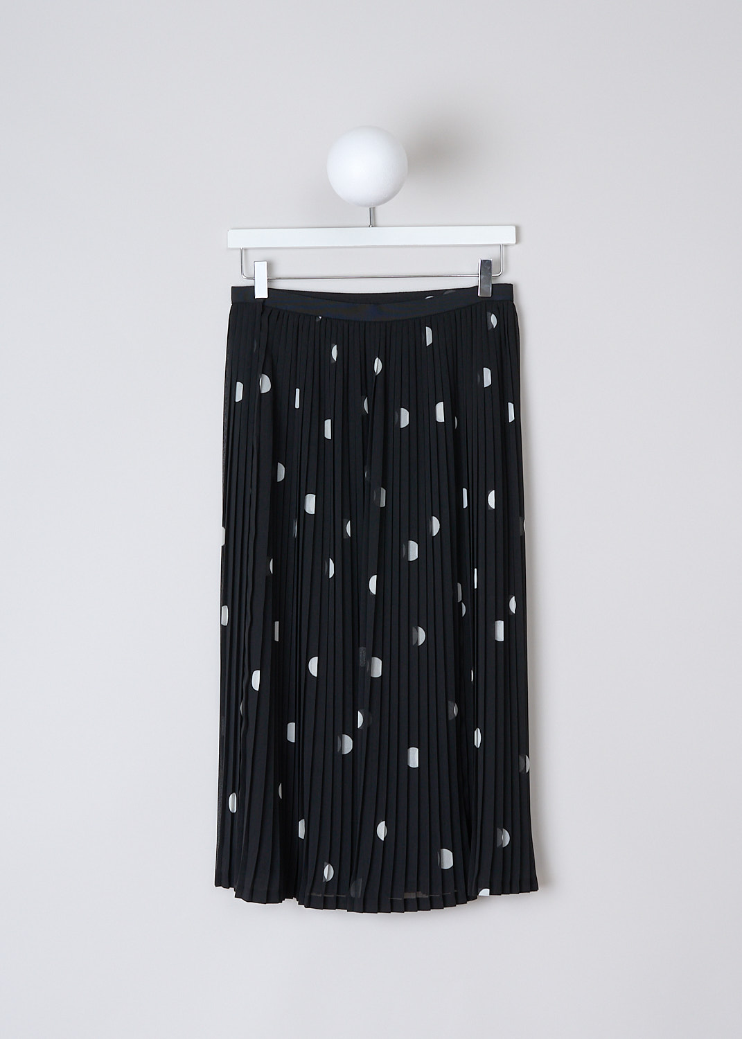 DRIES VAN NOTEN, BLACK PLEATED MIDI SKIRT WITH POLKA DOT PRINT, SARAM_9421_WW_SKIRT_DESA,  Black, White, Print, Back, This pleated midi skirt has a black base color with a white polka dot print. The skirt has a narrow black grosgrain waistband and a concealed side zip. Beneath the semi-sheer polka dotted top fabric, the skirt has a black underskirt with a back centre slit.   
