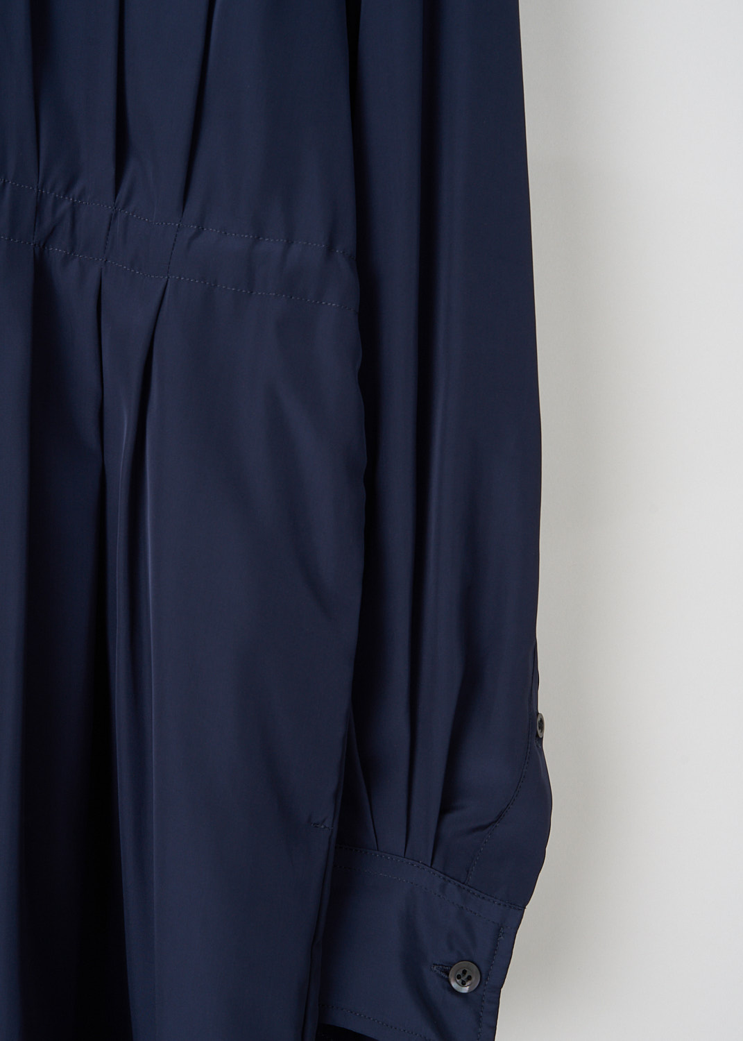 Dries van Noten, Navy blue Darlos shirt dress, DARLOS_8374_WW_DRESS_509_NAVY, Blue, Detail, This navy blue Darlos shirt dress has a classic collar and a concealed front button closure. The elasticated waistband gives and the internal draw cord cinch in the waist. The long voluminous sleeves have buttoned cuffs.  

