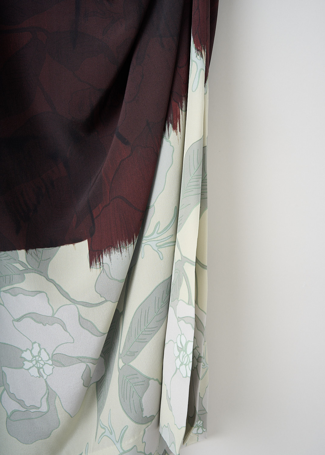 Dries van Noten, Didi dress in Brown, DIDI_9069_WW_DRESS_703_BROWN, Brown, Print, Detail 1, This Didi dress in Brown has a round cowl neckline and long sleeves. The fabric is draped to one side creating an asymmetric cinched silhouette. The skirt has a broad off-white print hem. 
