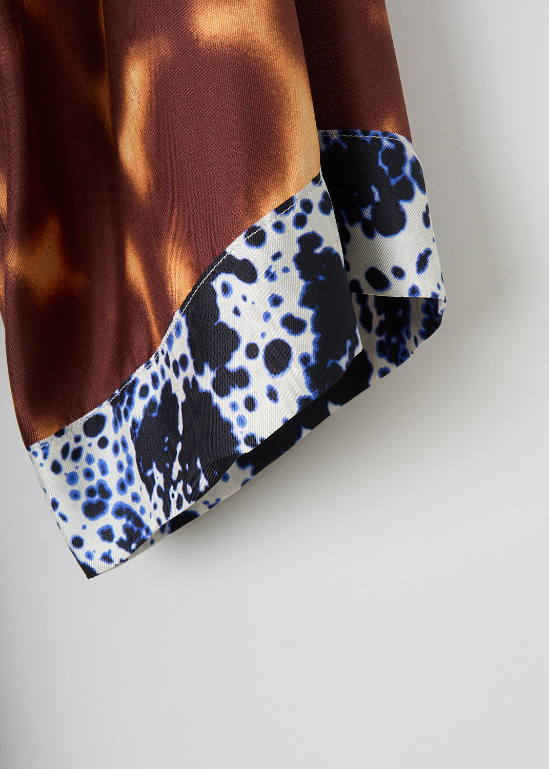 Dries van Noten, Doralia dress in Rust, DORALIA_1035_WW_DRESS_701_RUST, Brown, Orange, Print, Detail, This silk Doralia shirt dress has a rust-colored tie dye pattern. The dress has a spread collar and a concealed front button closure. On the front, the dress has a single breast pocket. Both the short sleeves and the straight hem have a contrasting trim. The dress comes with a matching fabric belt to cinch in the waist.
