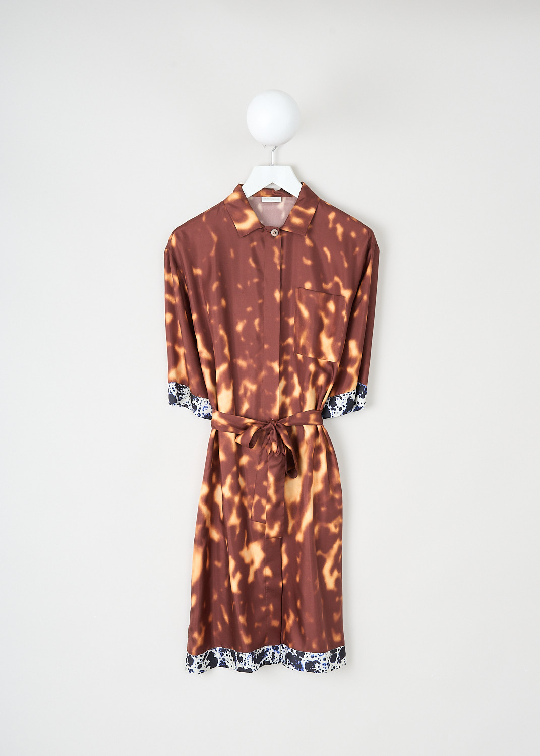 Dries van Noten, Doralia dress in Rust, DORALIA_1035_WW_DRESS_701_RUST, Brown, Orange, Print, Front, This silk Doralia shirt dress has a rust-colored tie dye pattern. The dress has a spread collar and a concealed front button closure. On the front, the dress has a single breast pocket. Both the short sleeves and the straight hem have a contrasting trim. The dress comes with a matching fabric belt to cinch in the waist.
