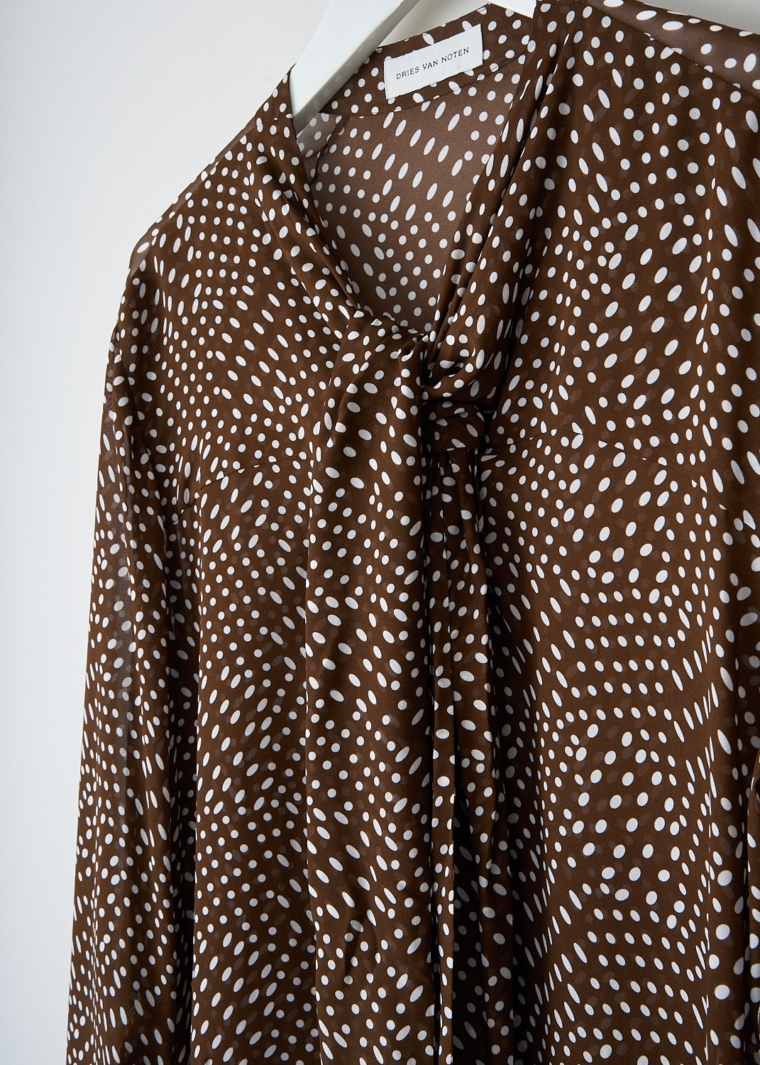 Dries van Noten, Durbi brown dress with dot-print, DURBI_2251_WW_DRESS_703_BROWN, Brown, White, Print, Detail, This Durbi mini dress has a brown base color with a white dot print throughout. The dress has a V-neck with a pussy bow detail. The long sleeves have buttoned cuffs.
