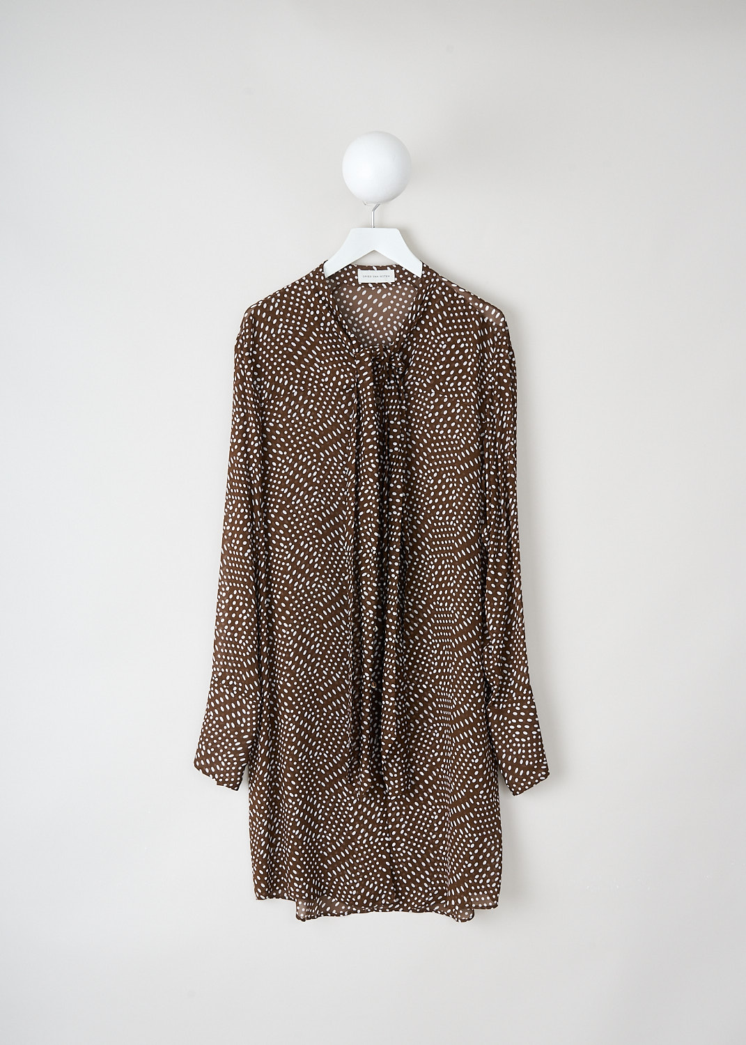 Dries van Noten, Durbi brown dress with dot-print, DURBI_2251_WW_DRESS_703_BROWN, Brown, White, Print, Front, This Durbi mini dress has a brown base color with a white dot print throughout. The dress has a V-neck with a pussy bow detail. The long sleeves have buttoned cuffs.
