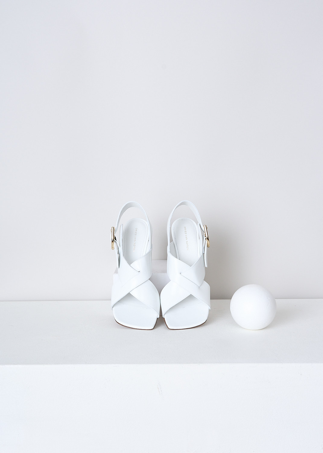 DRIES VAN NOTEN, WHITE HEELED OPEN-TOE SANDALS, WS231_668_QU104_WHITE001, White, Top, These white slingback pumps have an adjustable ankle strap with a gold-tone buckle. These pumps have a crisscross-strap across the vamp with a squared open toe. These pumps have a blocked heel.
