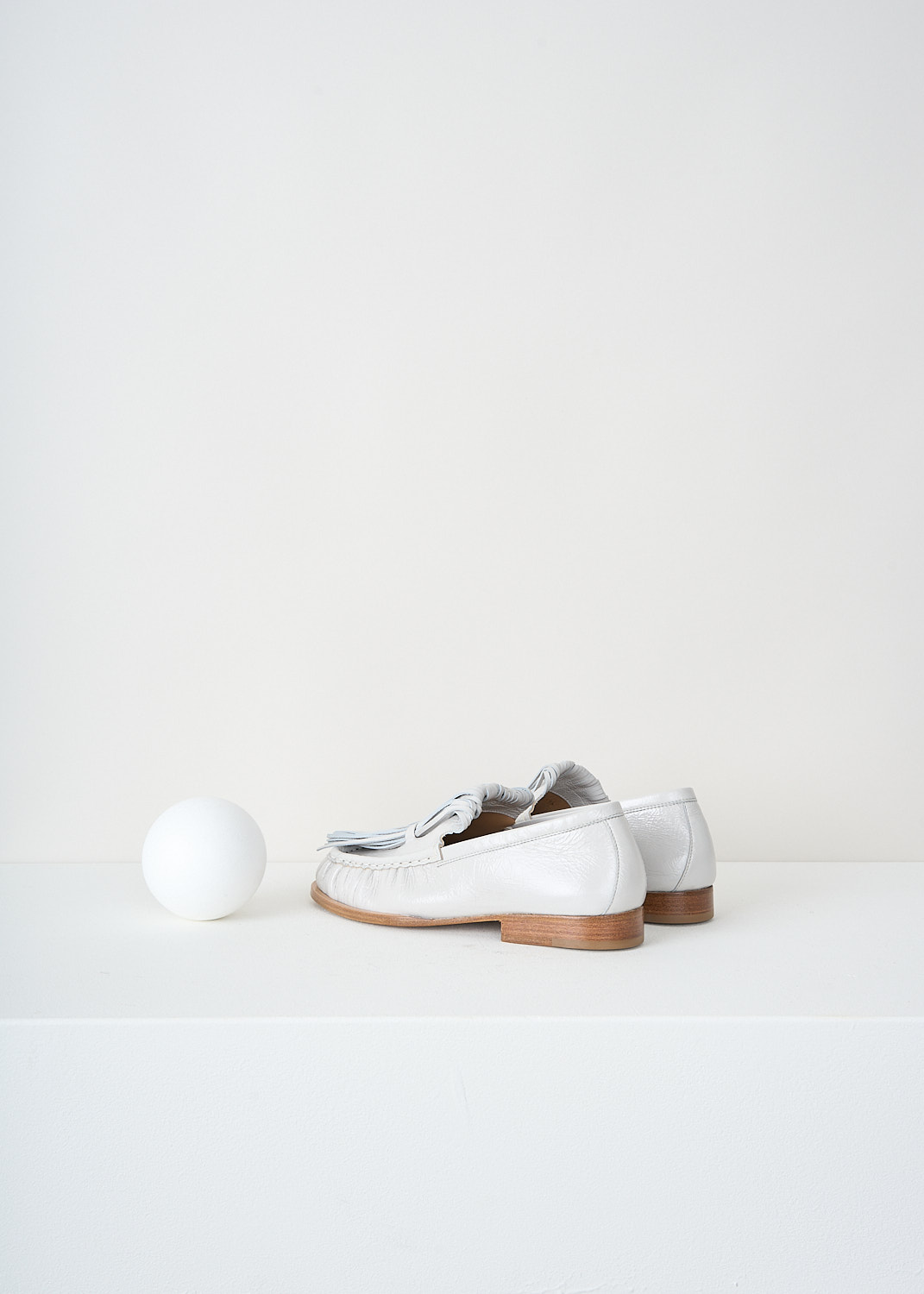 Dries van Noten, Off-white loafers with exaggerated tassels, 
WS241_1116_150_008_OFF_WHITE, White, Back, These off-white loafers have exaggerated tassels that curl  back to the toe and are held in place on the vamp. These loafers are pleated along the seams and have tan stacked soles.