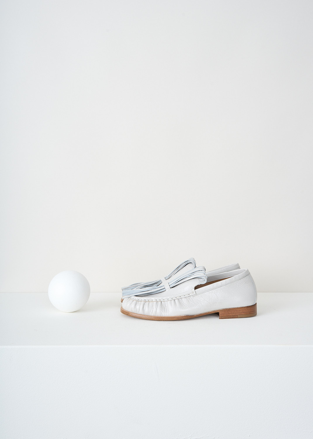 Dries van Noten, Off-white loafers with exaggerated tassels, 
WS241_1116_150_008_OFF_WHITE, White, Side, These off-white loafers have exaggerated tassels that curl  back to the toe and are held in place on the vamp. These loafers are pleated along the seams and have tan stacked soles.