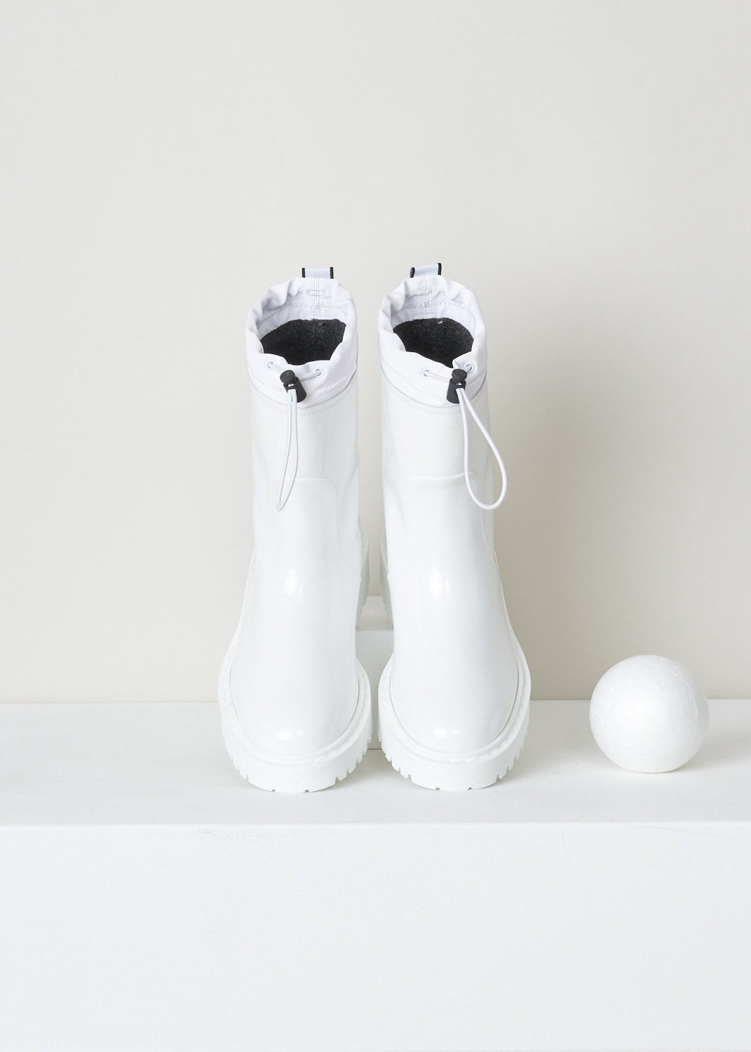 Hogan, Coated leather boots in metallic white, GYW5500DJ90P3OB001_P30_bianco, White, Top, These coated leather slip-on boots in metallic white have a cord-stop closure and a grosgrain pull-tab embroidered with the logo. These boots have a round toe. 
