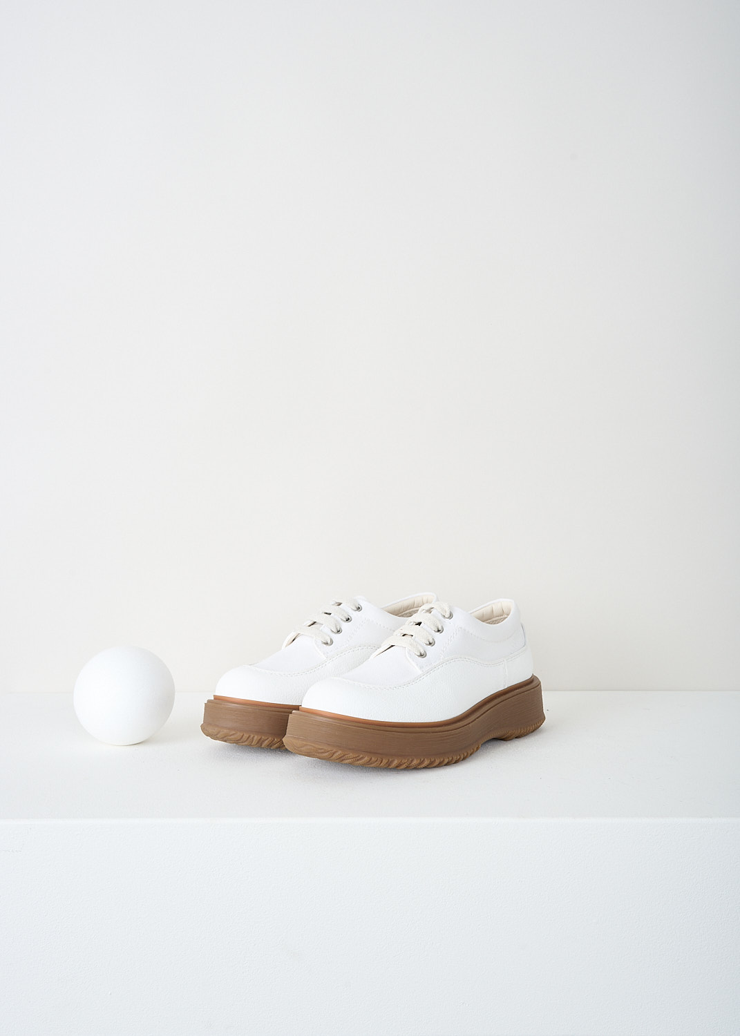 Hogan, White canvas shoes, H5W6020EF40Q_W6_B001, White, Front, These chunky white shoes have a lace-up closure with beige laces and a round toe. The exterior consists of white fabric with a broad synthetic edge. These shoes have a thick brown rubber sole. 
