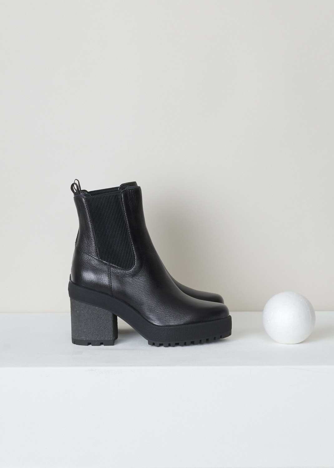 Hogan, Black pebble grain chelsea boots, HXW4750BZ70LF7B999_LF6_nero, black, front,  Black chelsea boots featuring a chunky heel and sole, furthermore this model comes with ribbed gusseted sides. The logo branded pull-tab can be found on the back of the shoe.
Heel height: 9 cm / 3.5 inch. 