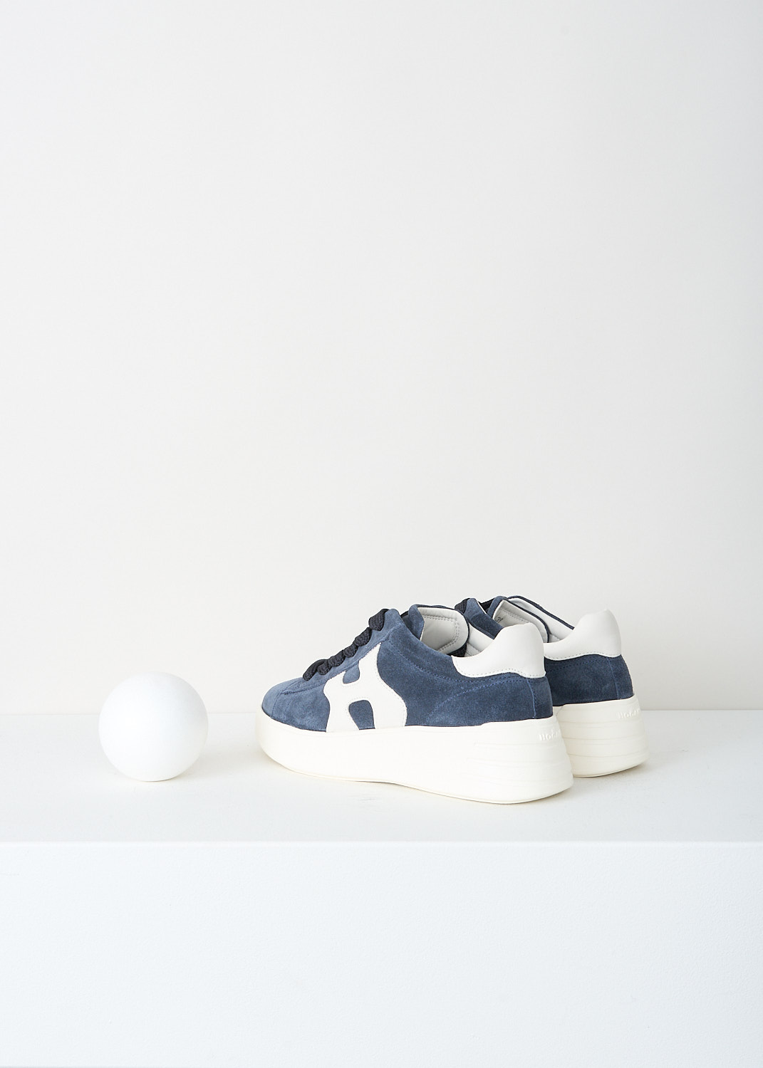 Hogan, Navy blue Rebel H562 sneakers, HXW5620DN61_PJQ_0RA0, Blue, Back, These navy blue Rebel H562 sneakers features a suede leather upper with smooth leather details and the signature Hogan H on the side. These low‑top sneakers have a lace‑up closure, a rubber outsole, and a memory foam insole. The sole gives a slight lift (around 5 cm).
