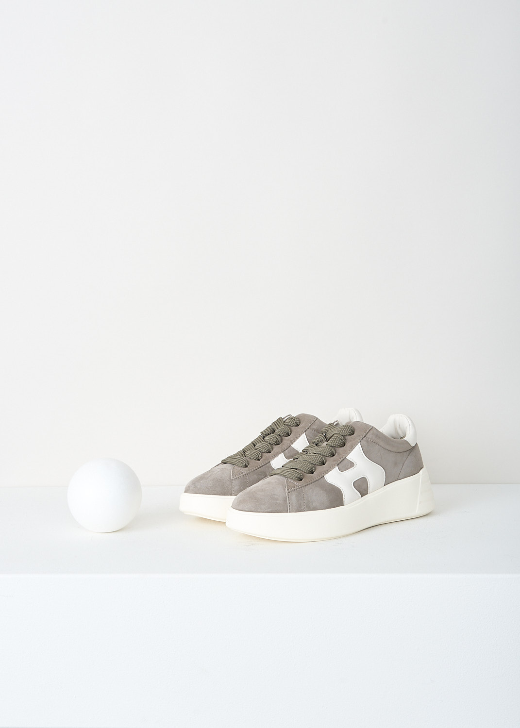 Hogan, Taupe Rebel H562 sneakers with white detail, HXW5620DN61_PK6_0GAA, Grey, Front, These taupe Rebel H562 sneakers features a suede leather upper with smooth leather details and the signature Hogan H on the side. These low‑top sneakers have a lace‑up closure, a rubber outsole, and a memory foam insole. The sole gives a slight lift (around 5 cm).
