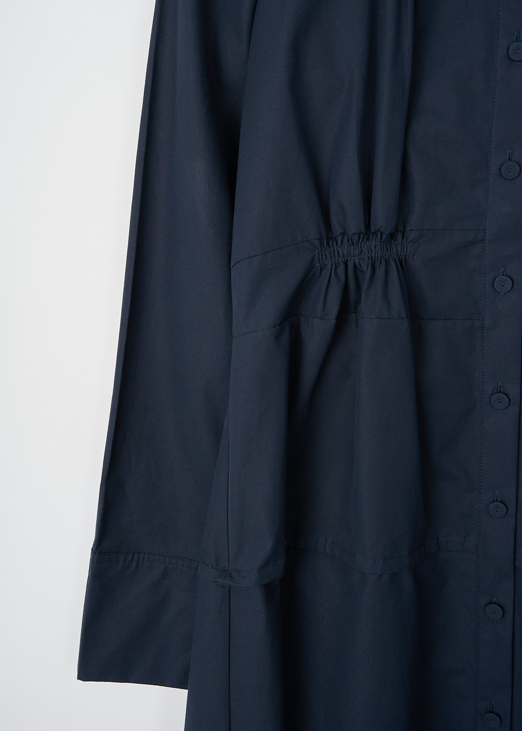 Jil Sander, Navy blue long-sleeve maxi dress, J04CT0002_J45002_401_NAVY, Blue, Detail, This navy blue long-sleeve maxi dress has a mandarin collar and a front button closure. The long sleeves have buttoned cuffs. The front and back have pleated detailing. The dress has a slightly flared skirt.
