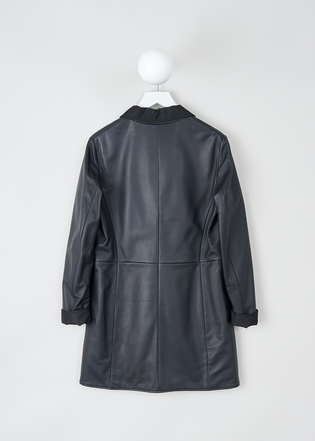 Jil Sander, Reversible dark blue Santander coat, SANTANDER_REV_L_NW6519076_WL562101A_402_DARK_BLUE, Blue, Back, This reversible dark blue Santander coat has a notched lapel and a front button closure. The long sleeves have a straight hem. The coat is reversible, with navy blue leather to one side and black polyester to the other side. On the leather side, the coat has slanted pockets. On the polyester side, the coat has patch pockets.  

