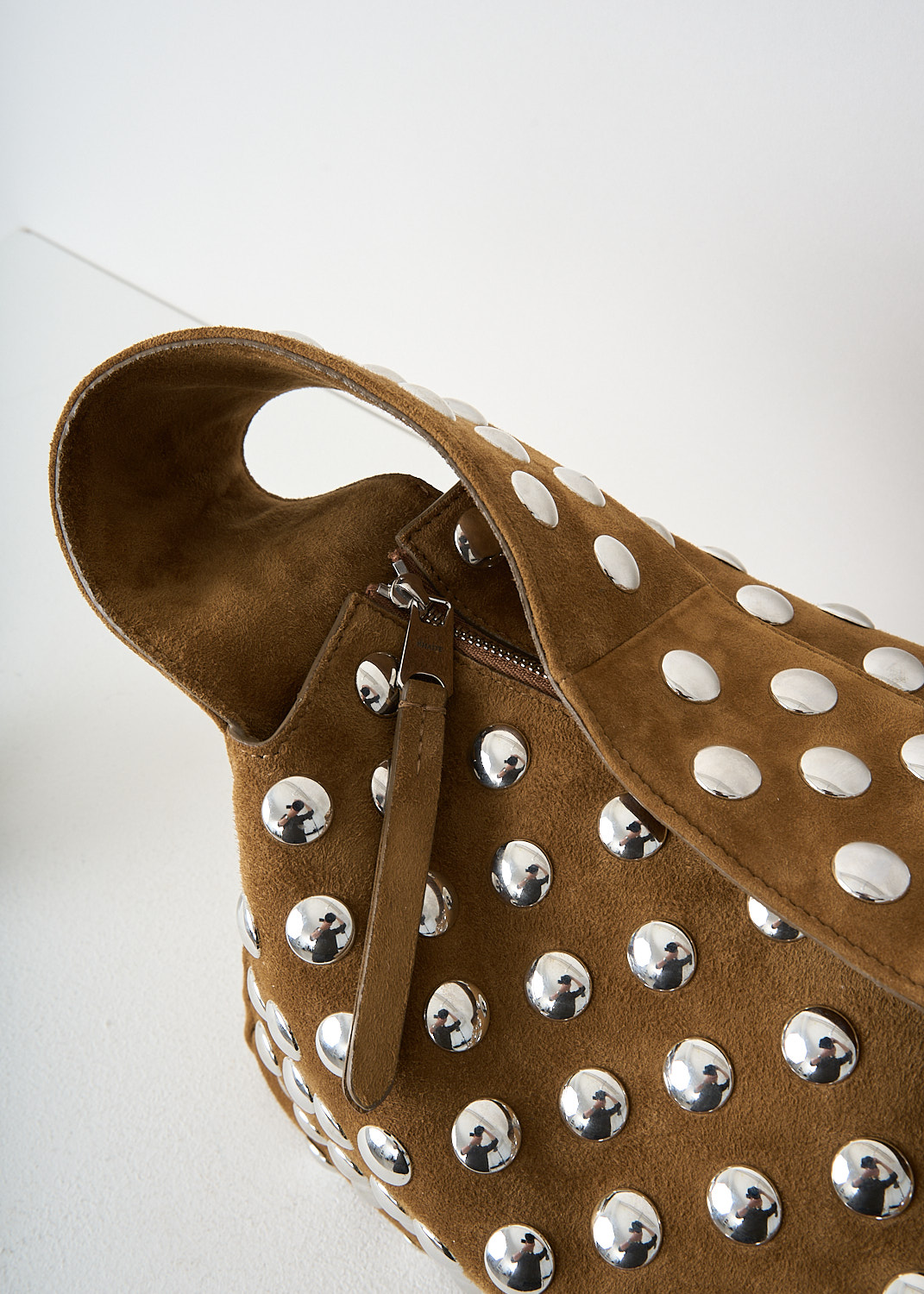 Khaite, Elena shoulder bag with silver studs in Mud, 
ELENA_SHOULDER_BAG_H2025_849_737_MUD, Brown, Detail, This Elena shoulder bag with silver studs in the color Mud has a single broad shoulder strap. The boxy bag has a top-zip closure that opens up to its spacious compartment with, to one side, a slip pocket. 