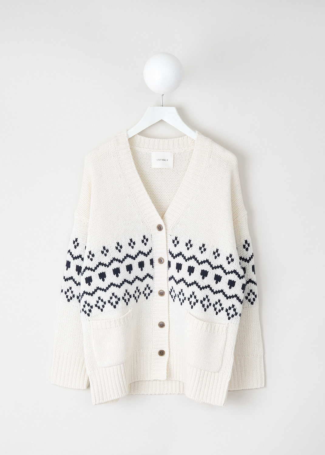 Lisa Yang, Greyson cardigan in Cream/navy, 2023254_GREYSON_CARDIGAN_CREAM_NAVY, White, Blue, Print, Front, This Greyson cardigan has a cream base color with a navy blue jacquard print. The cardigan has a V-neckline, long sleeves and a front button closure. The neckline, cuffs and hemline have a ribbed finish. On the front, the cardigan has two patch pockets.

