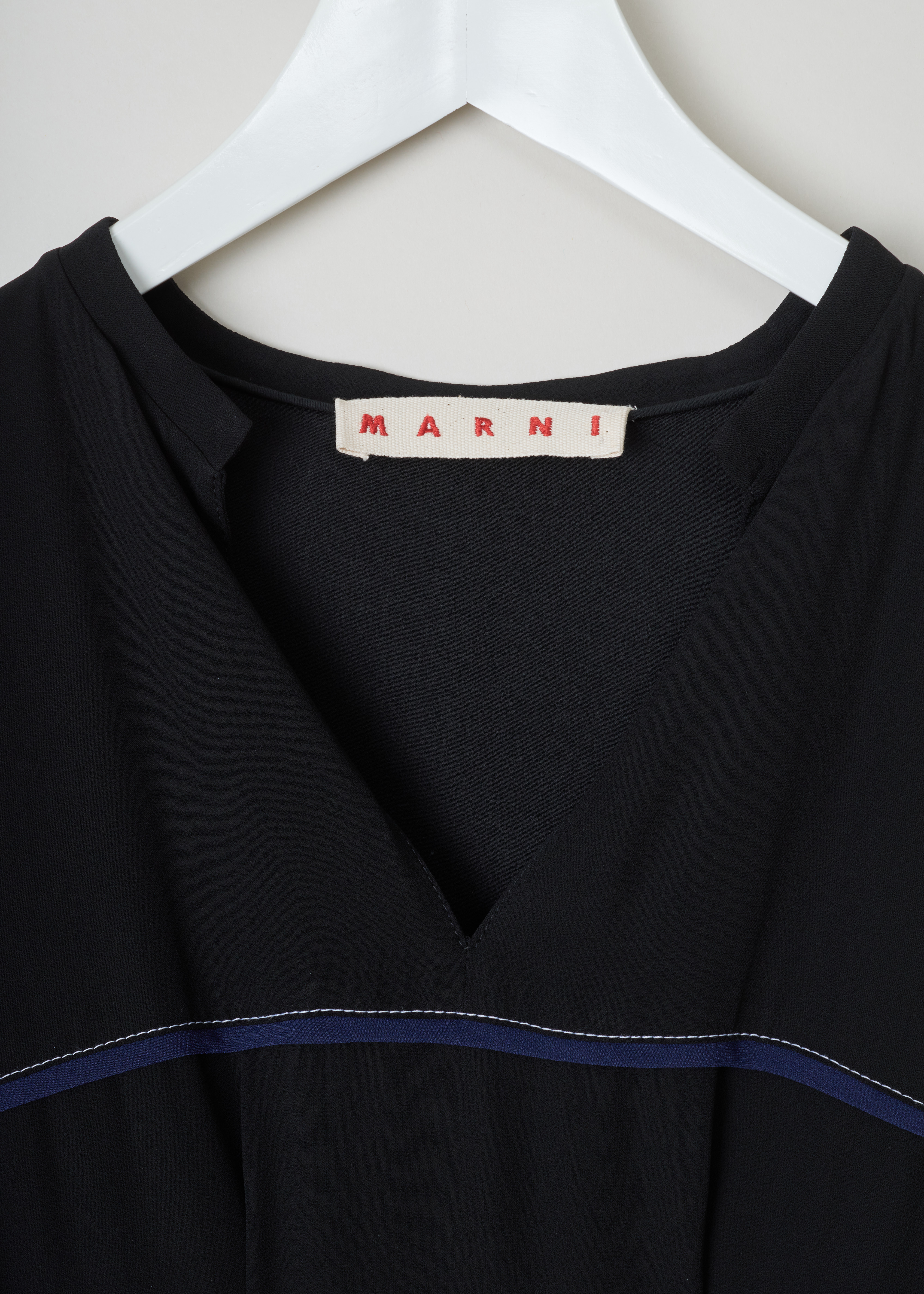 Marni Contrast stitch flared dress black ABMA032910_TV285_00N99_BLACK detail. Flared black midi-dress with white contrasting topstitching at the waist, blue bias on the chest, a V-neck, short puff sleeves and an irregular hemline.