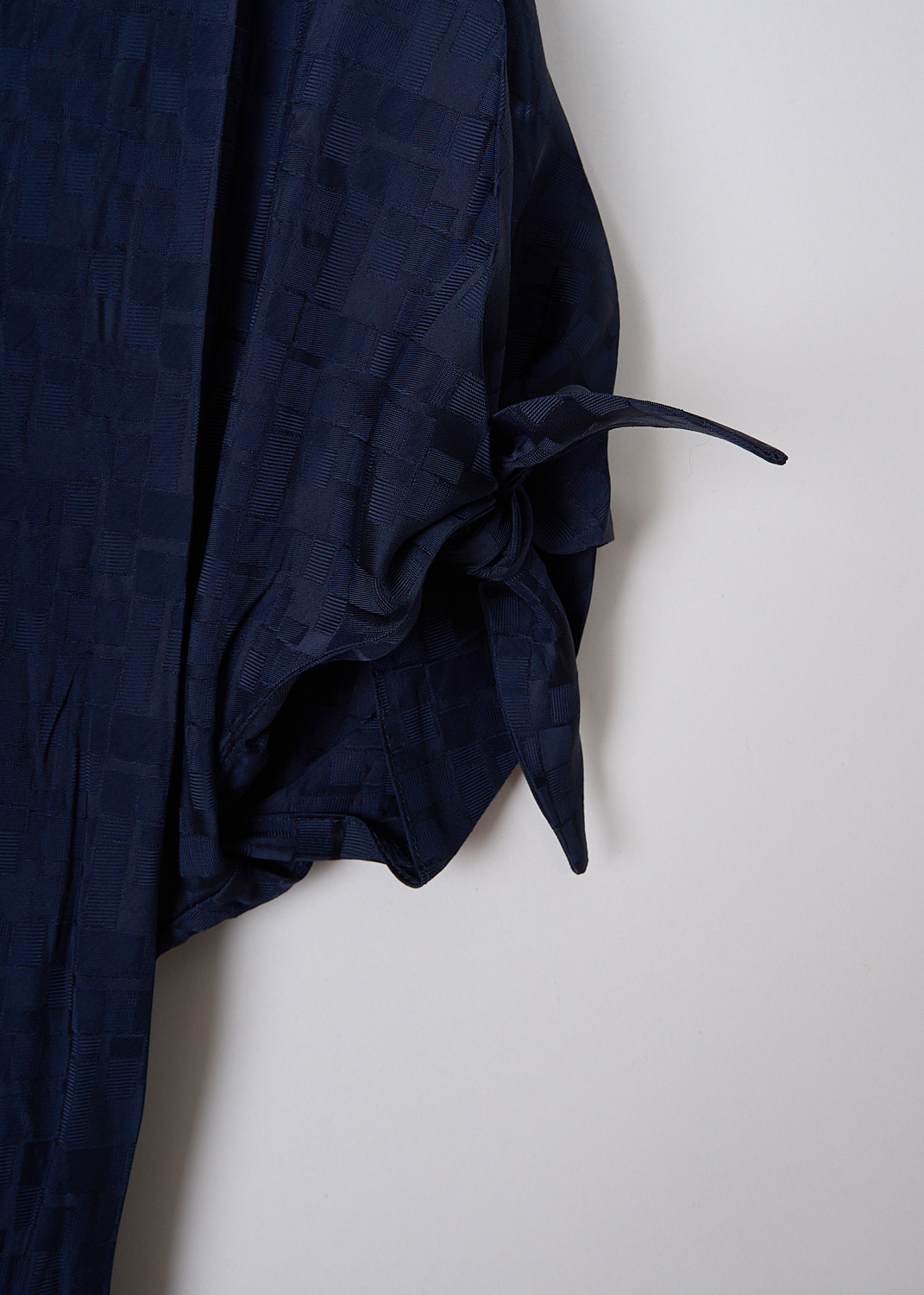 MARNI, INK BLUE FLUID JACQUARD MAXI DRESS, ABMA0871A0_UTV902_00B80, Blue, Detail 1 This Ink blue fluid maxi dress has a geometric jacquard print. The dress has a bow-tie neckline with a deep V. The short sleeves have tie cuffs. The long skirt flares out slightly at the bottom. The dress is fully lined.
