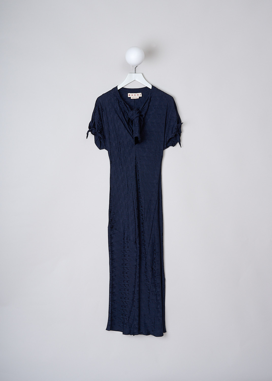 MARNI, INK BLUE FLUID JACQUARD MAXI DRESS, ABMA0871A0_UTV902_00B80, Blue, Front, This Ink blue fluid maxi dress has a geometric jacquard print. The dress has a bow-tie neckline with a deep V. The short sleeves have tie cuffs. The long skirt flares out slightly at the bottom. The dress is fully lined.
