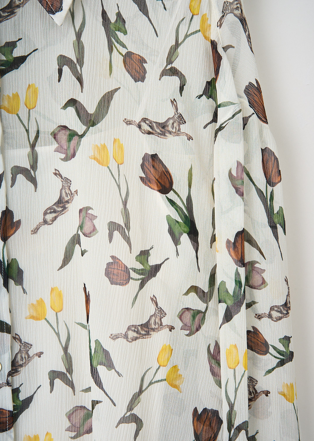 Close-up of the Marni tulips and hares print on semi-sheer fabric with classic collar and button closure.