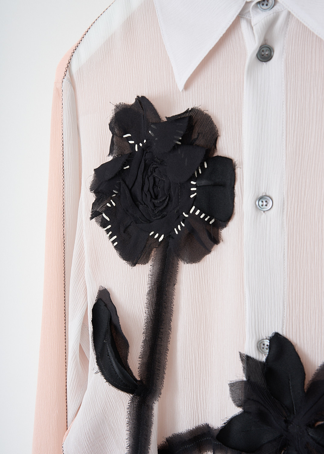 Marni, Soft pink blouse with floral-appliqué, CAMA0606X1_UTSG22_00N15, Pink, Detail, This semi see-through soft pink blouse has a black tulle floral-appliqué on the front. The blouse has a classic collar and a front button closure. The long sleeves have buttoned cuffs. In the back, the blouse has a centre box pleat. The blouse has a rounded hem. 
