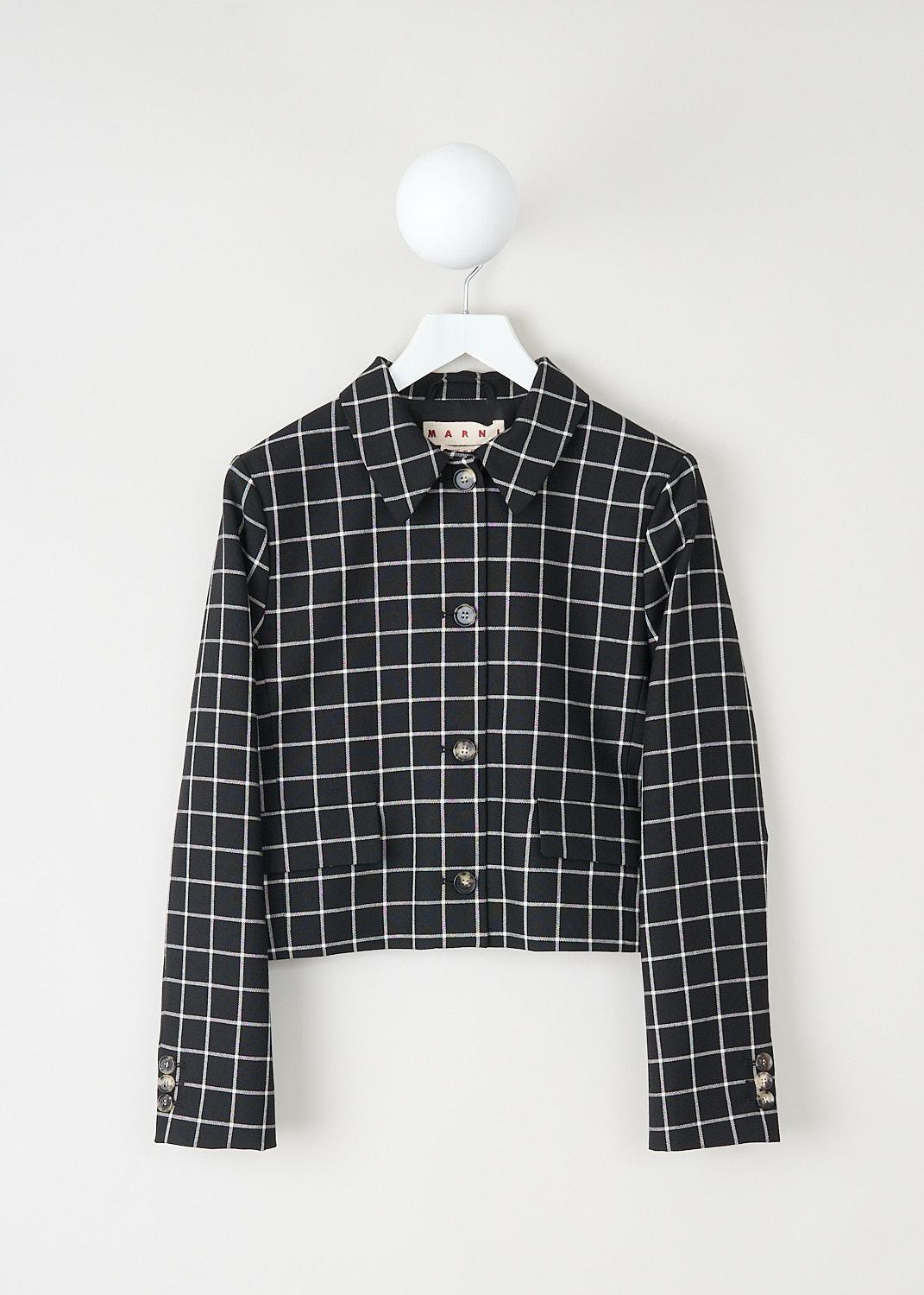 Marni, Cropped black jacket with grid pattern, 
GIMA0221U0_UTWA01_CHN99, Black, White, Print, Front, This cropped black jacket has a white wool-jacquard grid pattern. The jackets has a spread collar and a front button closure. The long sleeves have buttoned cuffs. On the front, the jacket has flap welt pockets.
