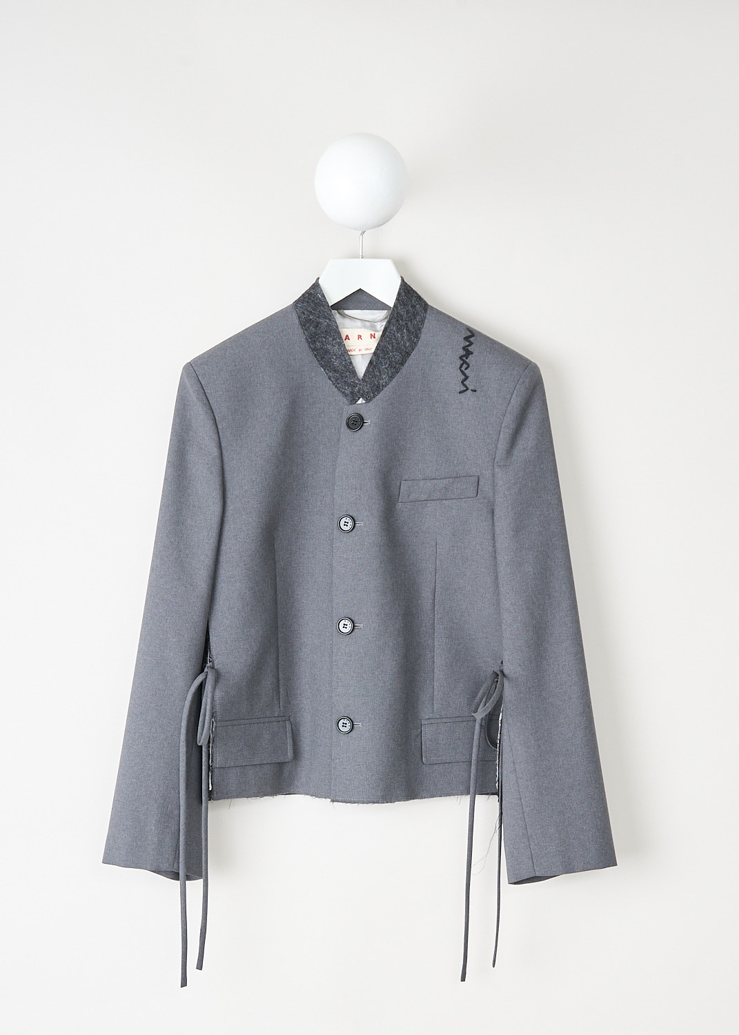 Grey wool jacket with dark grey felted collar, front button closure, and flap welt pockets by Marni, available at designer boutique Kiki's Stocksale in Maastricht.