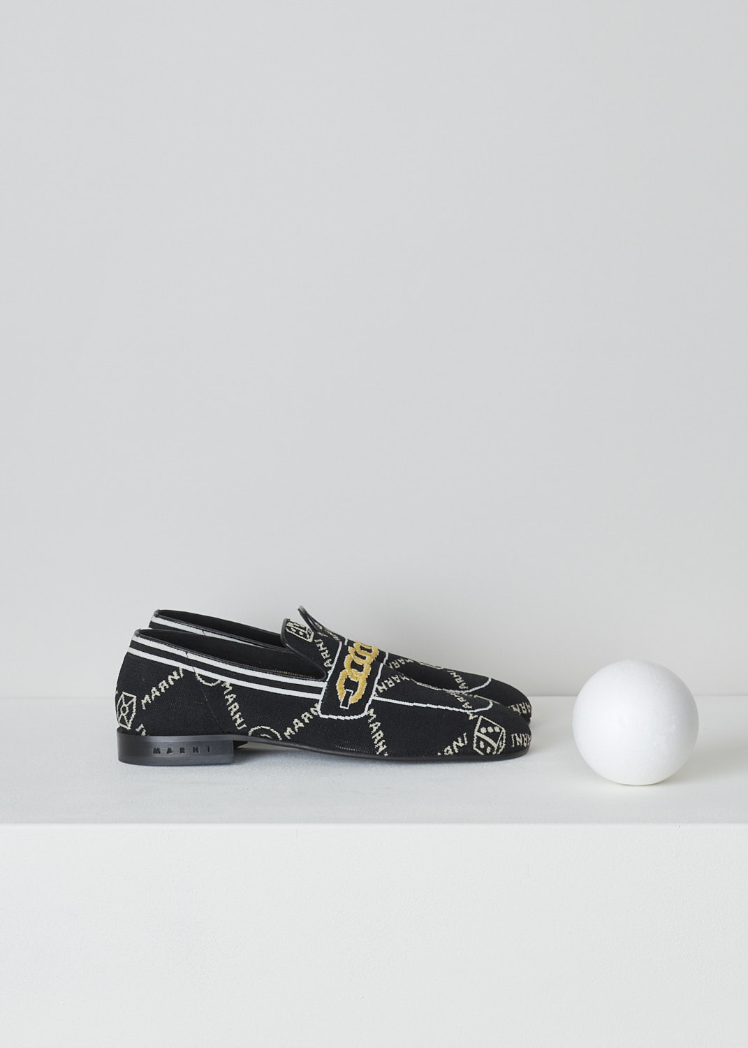 MARNI, BLACK TROMPE L'OEIL JACQUARD MOCCASINS, MOMS003601_P4601_Z2Q23, Black, Side, These black knitted moccasins have a trompe l'oeil image woven into them which depicts a gold chain across the vamp. The brand's logo is woven into them throughout the shoe in white. These moccasins have a round toe and flat rubber sole with a small heel. 
