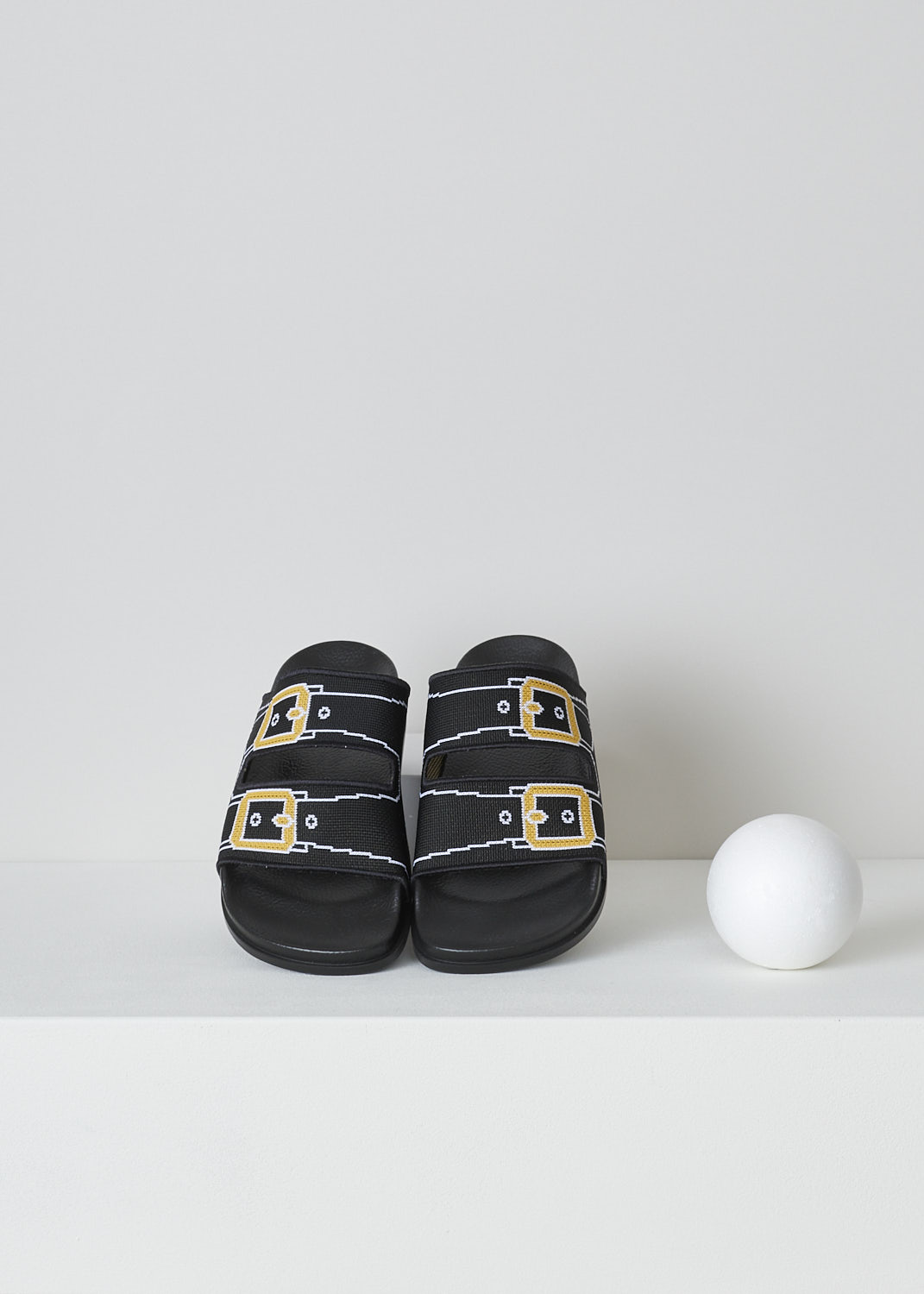 MARNI, BLACK TROMPE L'OEIL JACQUARD SLIDES, SAMS015802_P4547_ZO137, Black, Top, These black knitted slides have a trompe l'oeil image woven into the straps across the vamp. The image depicts straps with gold buckles. The brand's logo is woven into the side. These slip-on slides have a round open toe. The slides have a molded footbed and a flat rubber sole. 
 
 
