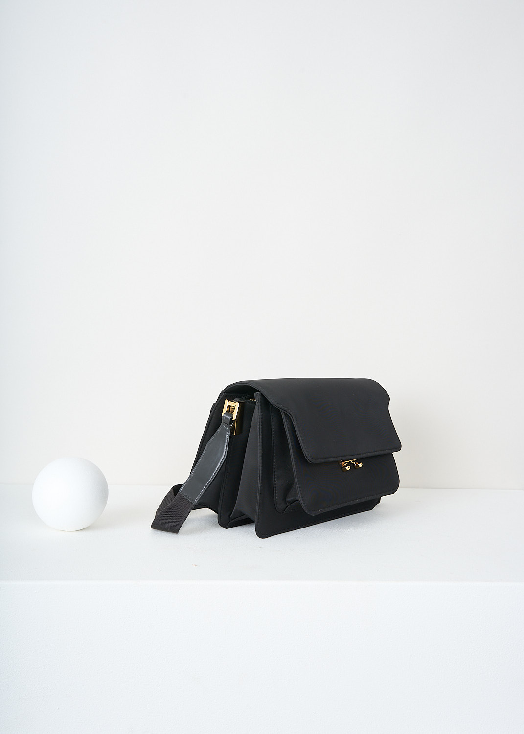 Marni, Medium black nylon trunk bag, SBMP0090Q0_TN685_Z3O20, Black, Side, This Medium black nylon trunk bag has a broad adjustable shoulder strap. The flap closure opens up to five compartments; one slip pocket and one with a zip closure. Gold-tone hardware has been used throughout. 

