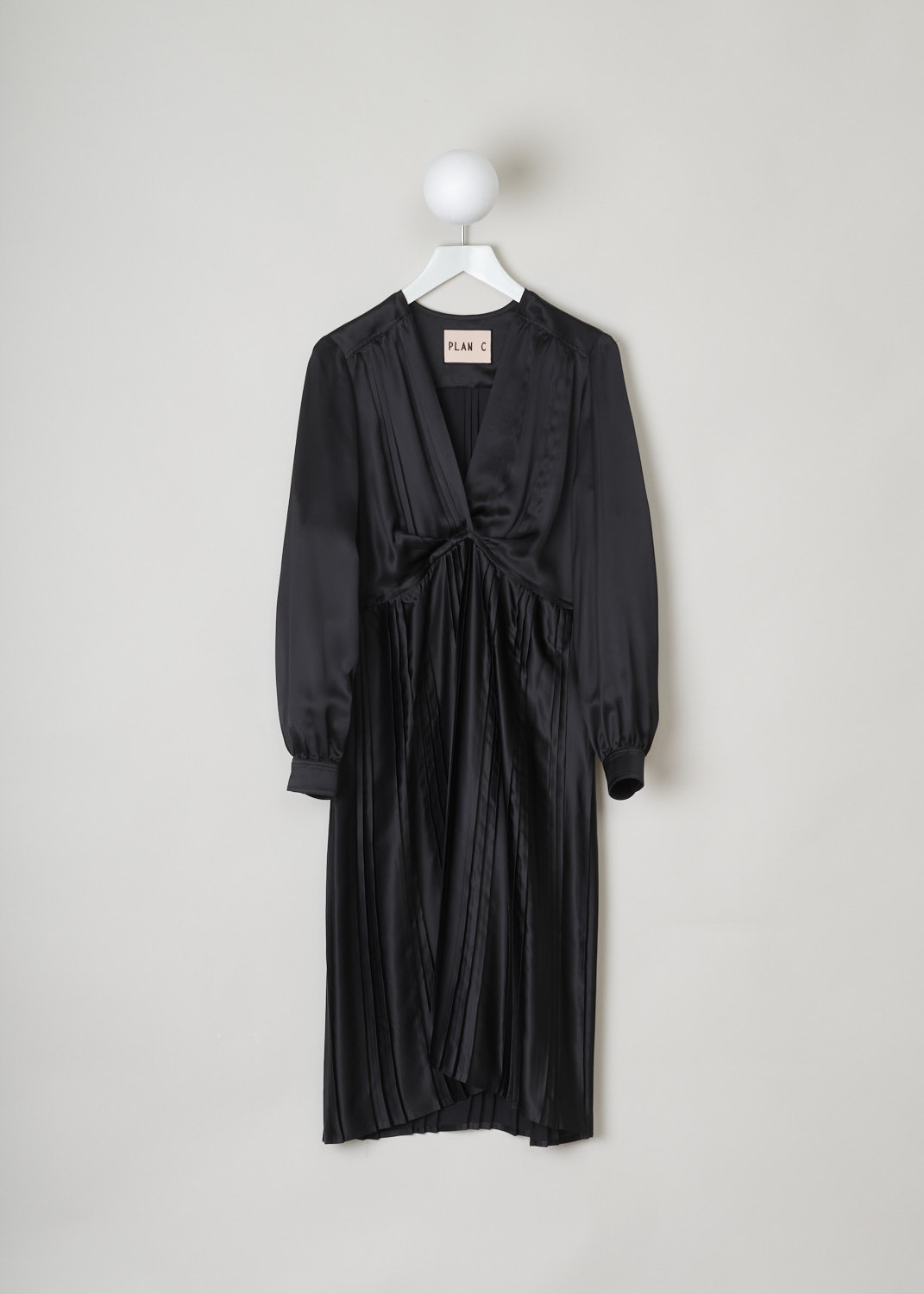 Plan C, Black empire dress, ABCAC58KE0_TV017_00N99, Black, Front, This black midi empire dress has a pleated front with a V-neckline. The long sleeves have buttoned cuffs. In the back, the dress pleated. The dress has a straight hemline.

