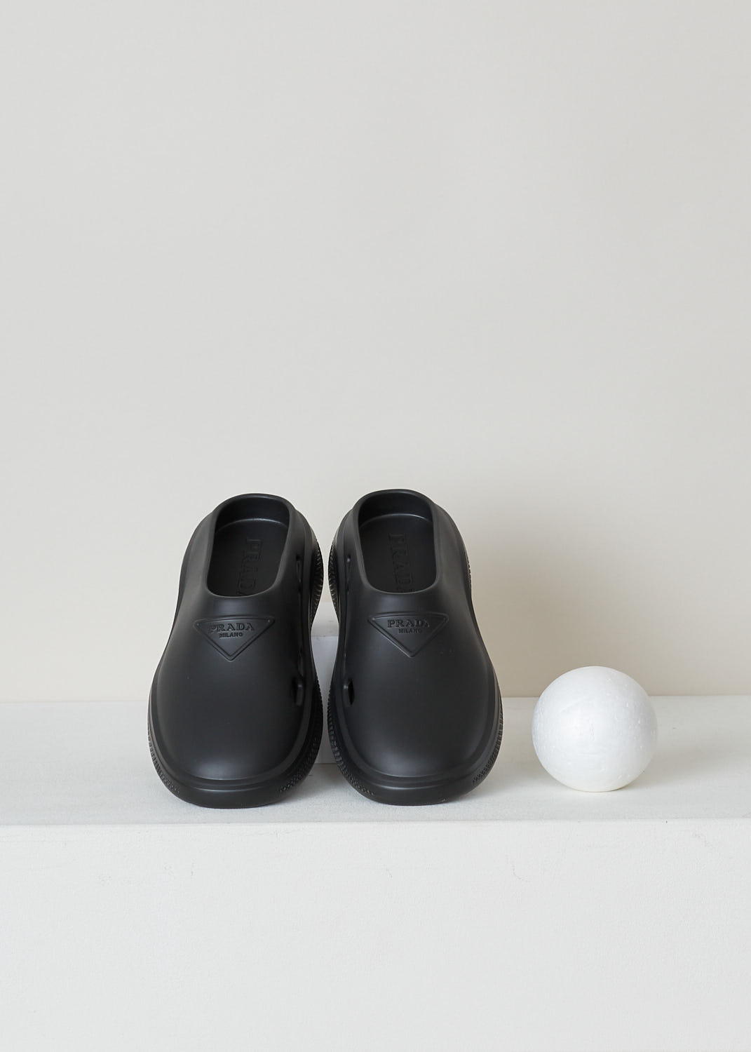 PRADA, BLACK SLIDES, 1S811M_3LKD_F0002_9_99_F_025_CALZATURE_DONNA_MELLOW_NERO, Black, Top, These black slip-on style slides have a round toe with an embossed logo on the front. These slides have chunky soles. 
