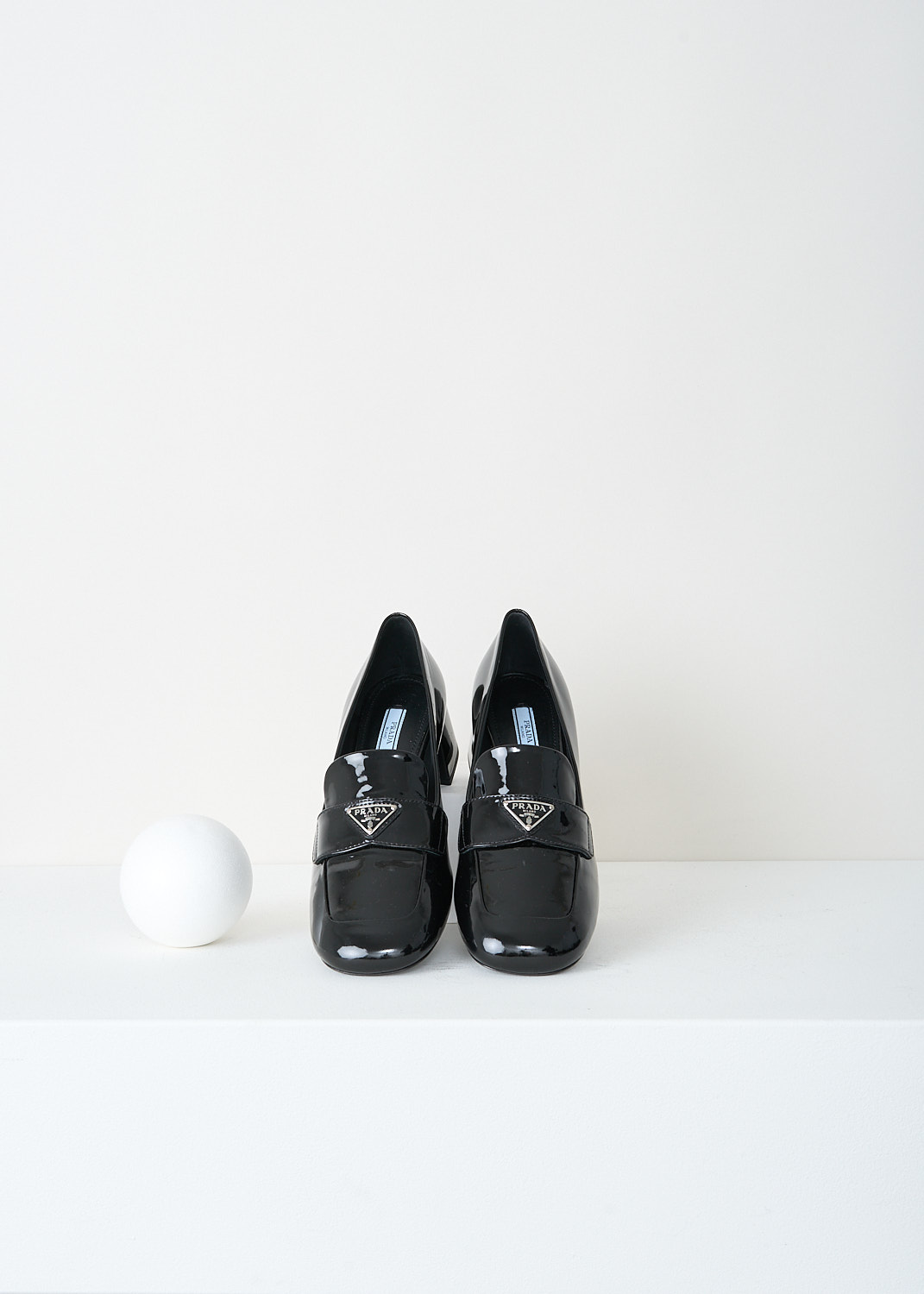 Prada, Black patent leather loafers with block heel, 069_VERNICE_1D763M_F0002_NERO, Black, Top, These black patent leather loafers feature a round toe, a block heel, and a strap across the vamp with the brand’s signature triangle logo on the front.
