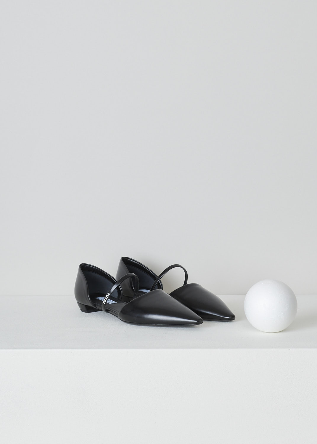 PRADA, POINTED BLACK BALLERINA FLATS, 1F519M_055_F0002_NERO, Black, Front, These black leather slip-on ballerina flats have a pointed toe and a decorative strap across the vamp with the band's logo in white. These ballerina flats have a small heel. 

