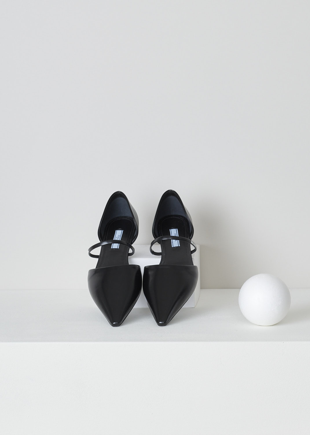 PRADA, POINTED BLACK BALLERINA FLATS, 1F519M_055_F0002_NERO, Black, Top, These black leather slip-on ballerina flats have a pointed toe and a decorative strap across the vamp with the band's logo in white. These ballerina flats have a small heel. 

