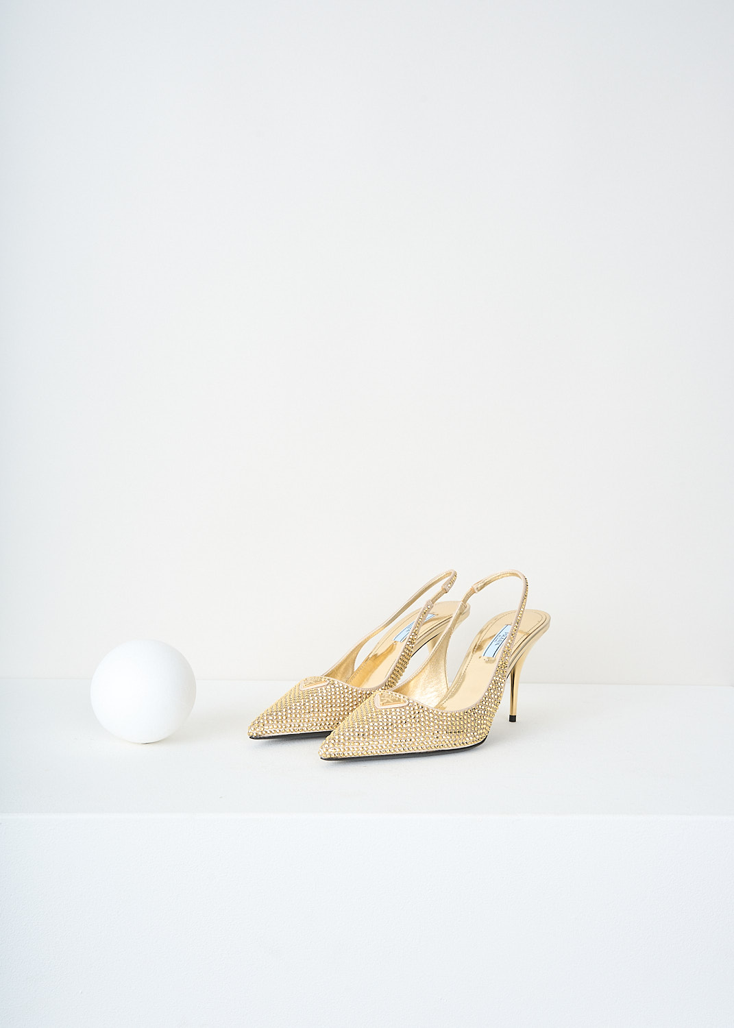 Prada, Gold crystal slingback pumps, 2AWL_CRYSTAL_1I021N_F0522_PLATINO, Gold, Front, These all-over gold-tone crystal embellished slingback pumps have a pointed toe with the brand' signature triangle logo on them. These pumps have an elasticated ankle strap and a small heel.
