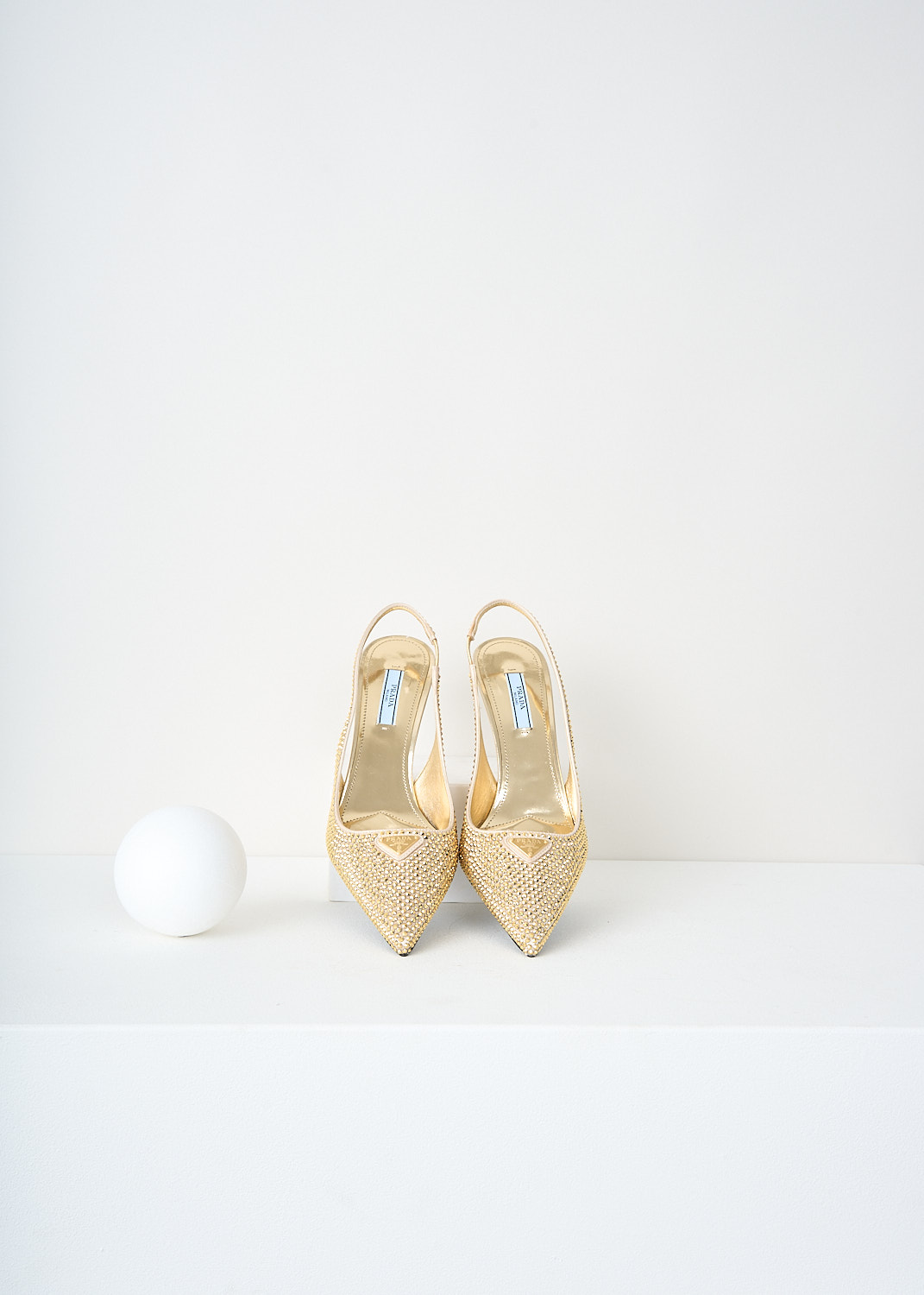 Prada, Gold crystal slingback pumps, 2AWL_CRYSTAL_1I021N_F0522_PLATINO, Gold, Top, These all-over gold-tone crystal embellished slingback pumps have a pointed toe with the brand' signature triangle logo on them. These pumps have an elasticated ankle strap and a small heel.
