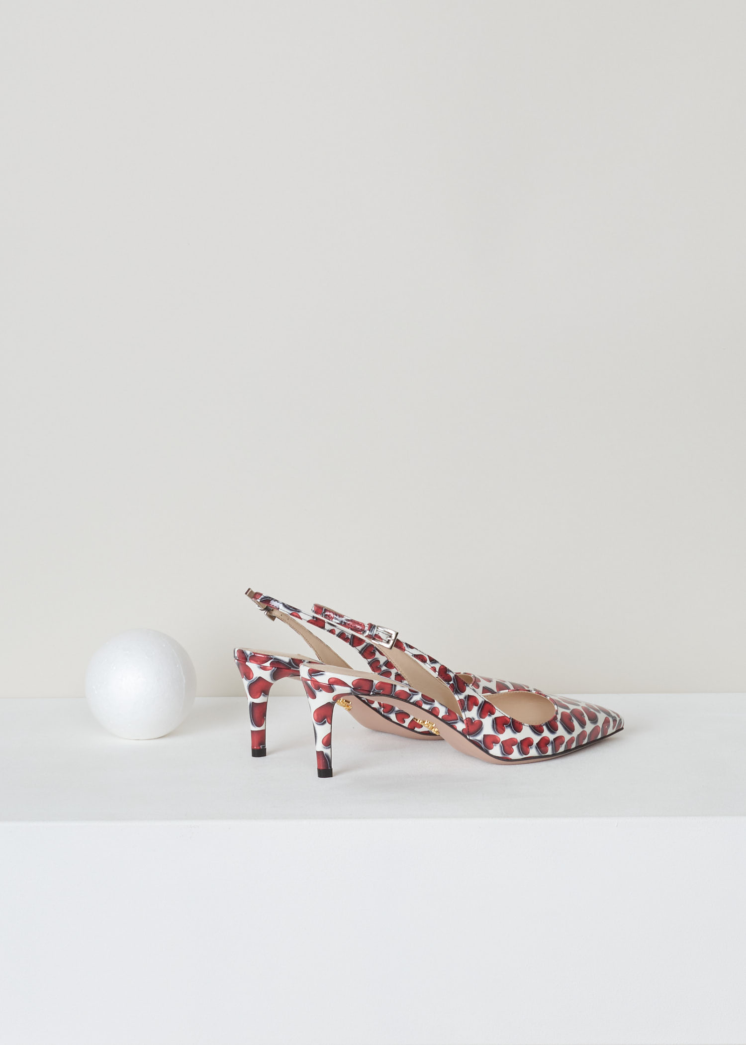 Prada, Red and white patent leather heart print, vernice_cuori_1I833I_F0D56_scarlatto, red white, back, Red and white heart printed slingback. Pointed toe and mid high stiletto heel. With a gold-tone logo plaque on the sole.